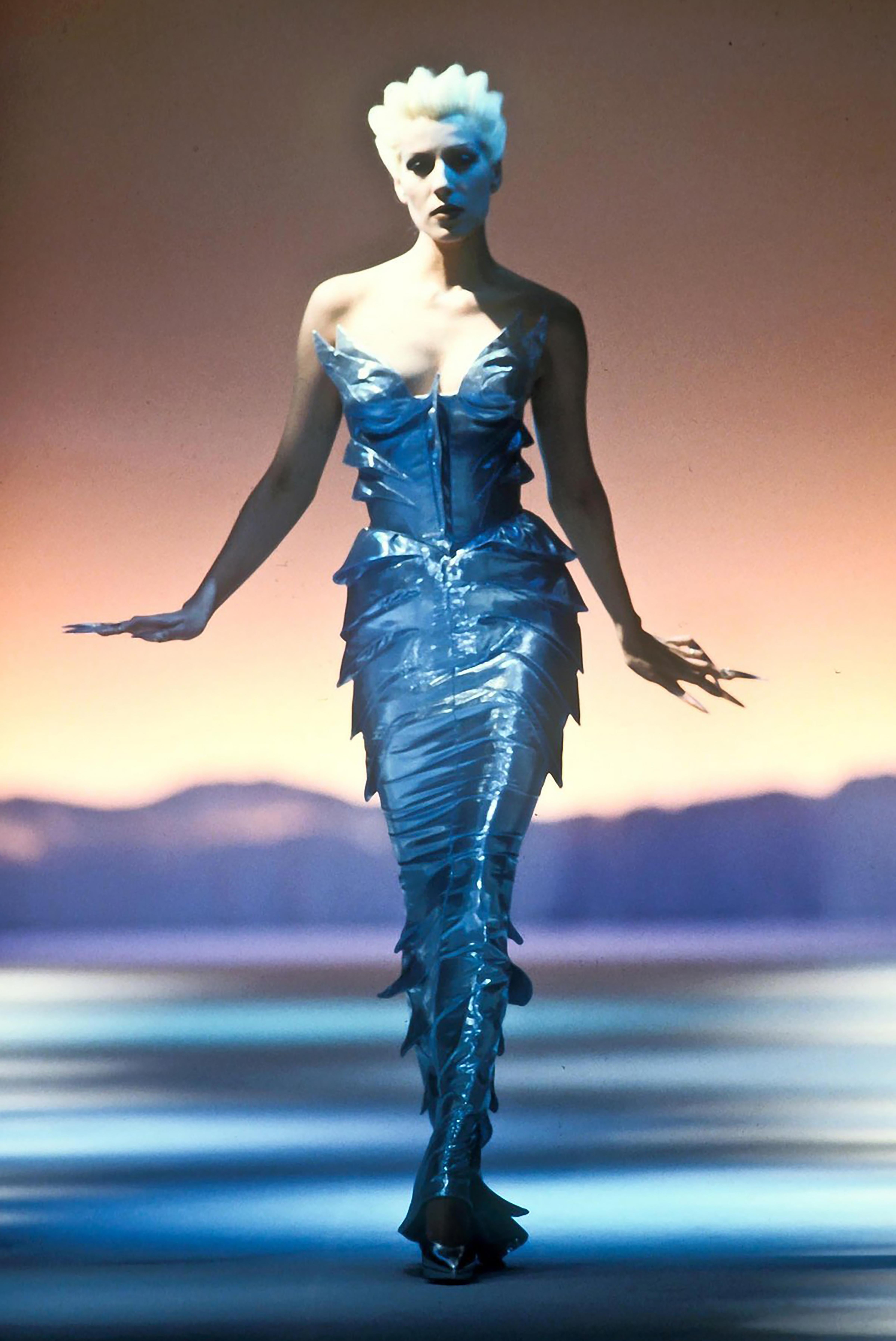 S/S 1989 Thierry Mugler Couture 'Atlantis' Collection metallic mermaid set. Extremely rare one-of-one metallic purple lamé set with pointed 'fin' details throughout top and skirt. Fabric Contents: 67% Silk; 33% Polyester. Corset top features pointed