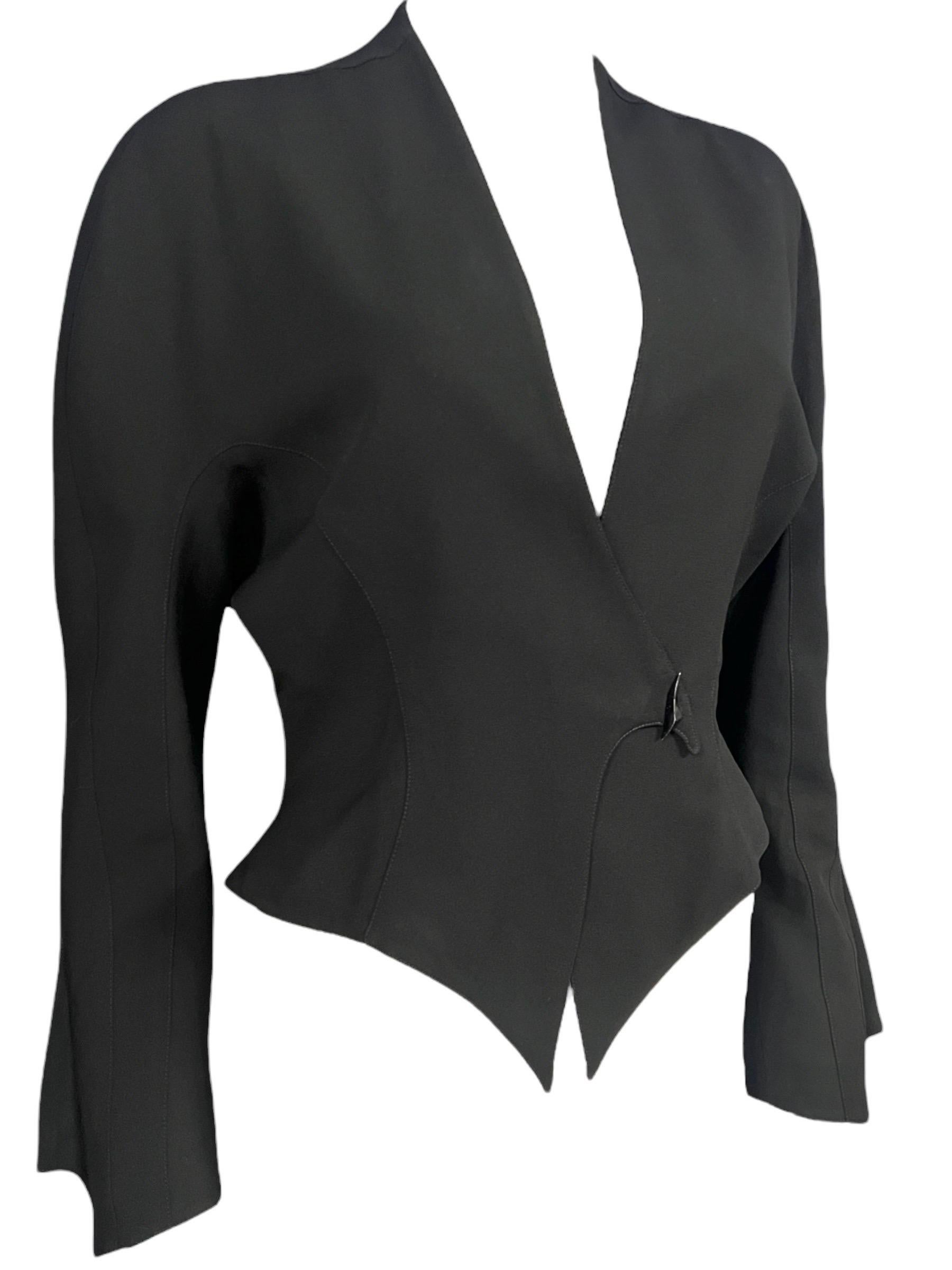 Spring Summer 1989 “Les Atlantes” Thierry Mugler black jacket featuring sculptural “fin” sleeves that flare subtly at the cuffs creating an architectural look. Its sharply pointed hem and angular side flares create a striking hourglass