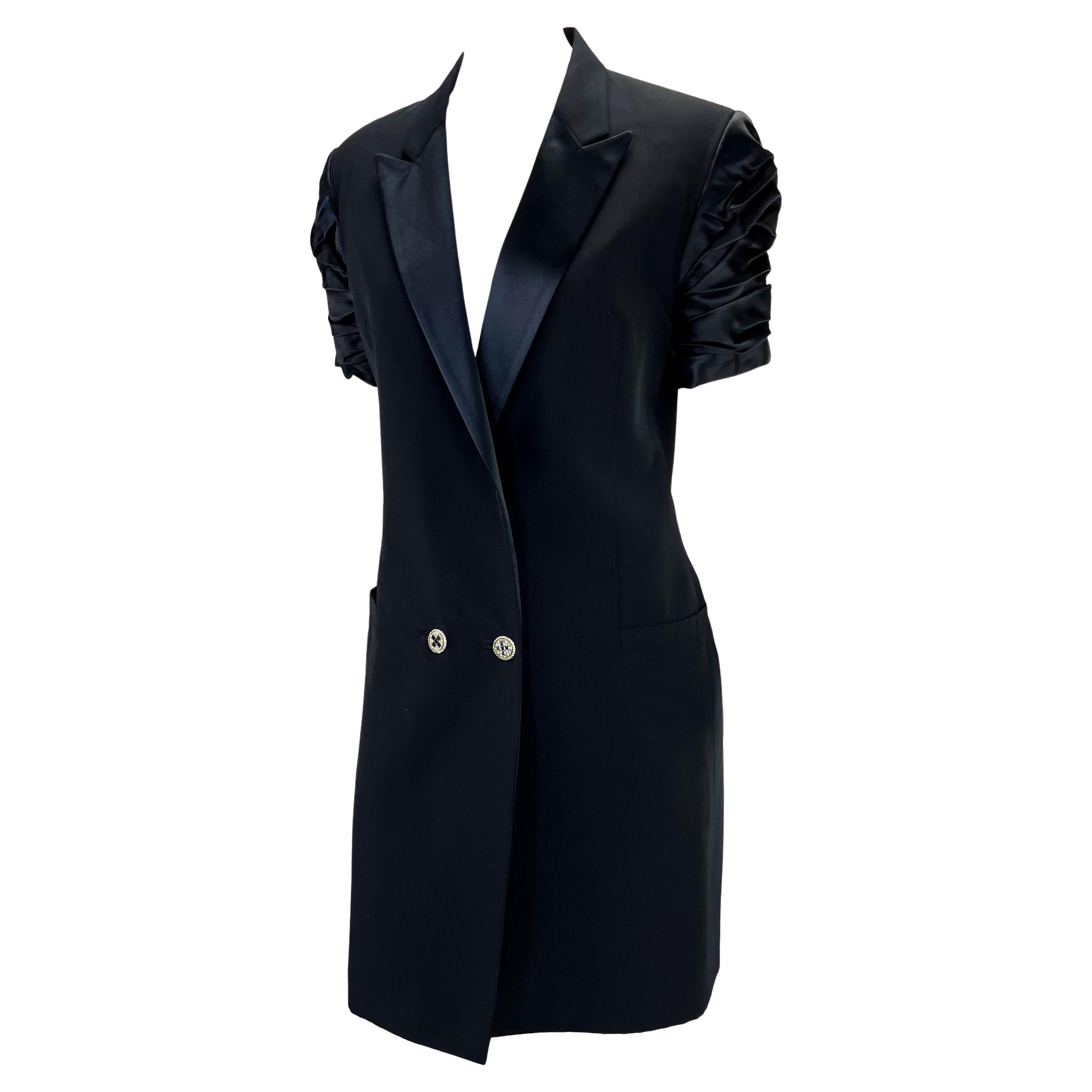 Presenting an incredible navy tuxedo style Gianni Versace Couture dress, designed by Gianni Versace. From the Spring/Summer 1990 collection, this fabulous dress features a plunging v-neckline, ruched satin short sleeves, pockets at the hips, and a