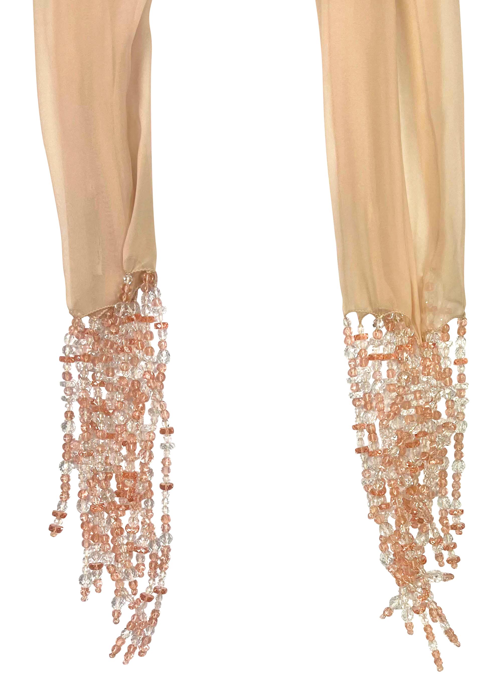 This Dolce & Gabbana scarf from the Spring/Summer 1991 collection features delicate pale pink sheer chiffon, adorned with sparkling crystal beaded fringe at both ends.

Approximate measurements:
Length: 51