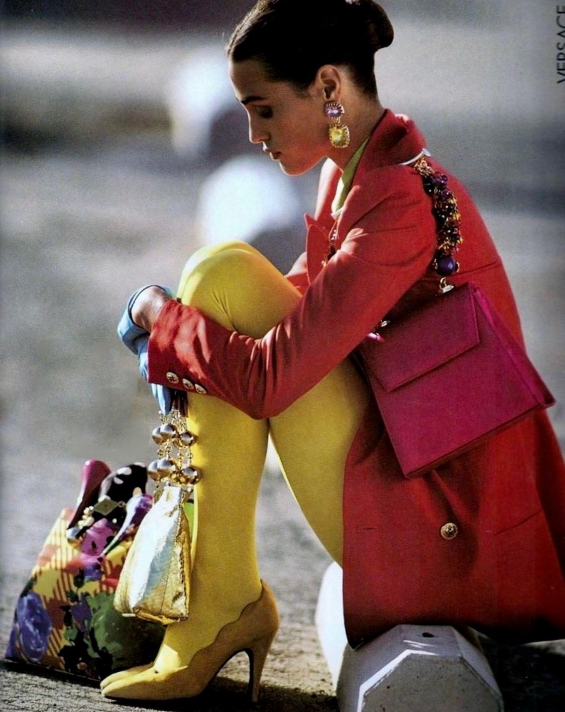 Presenting a Fuschia silk satin Gianni Versace top handle bag, designed by Gianni Versace. From the Spring/Summer 1991 collection, a version of this bag was highlighted in an editorial shoot of the April 1991 issue of Elle Sweden, photographed by