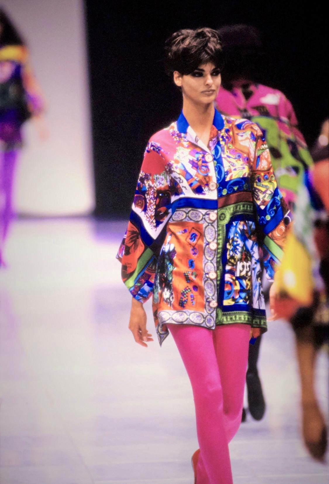 Presenting a gorgeous pop art printed oversized tunic blouse designed by Gianni Versace for his Spring/Summer 1991 collection. The front and back feature two contrasting color palettes and four framed vignettes on each side, full of deep colors and