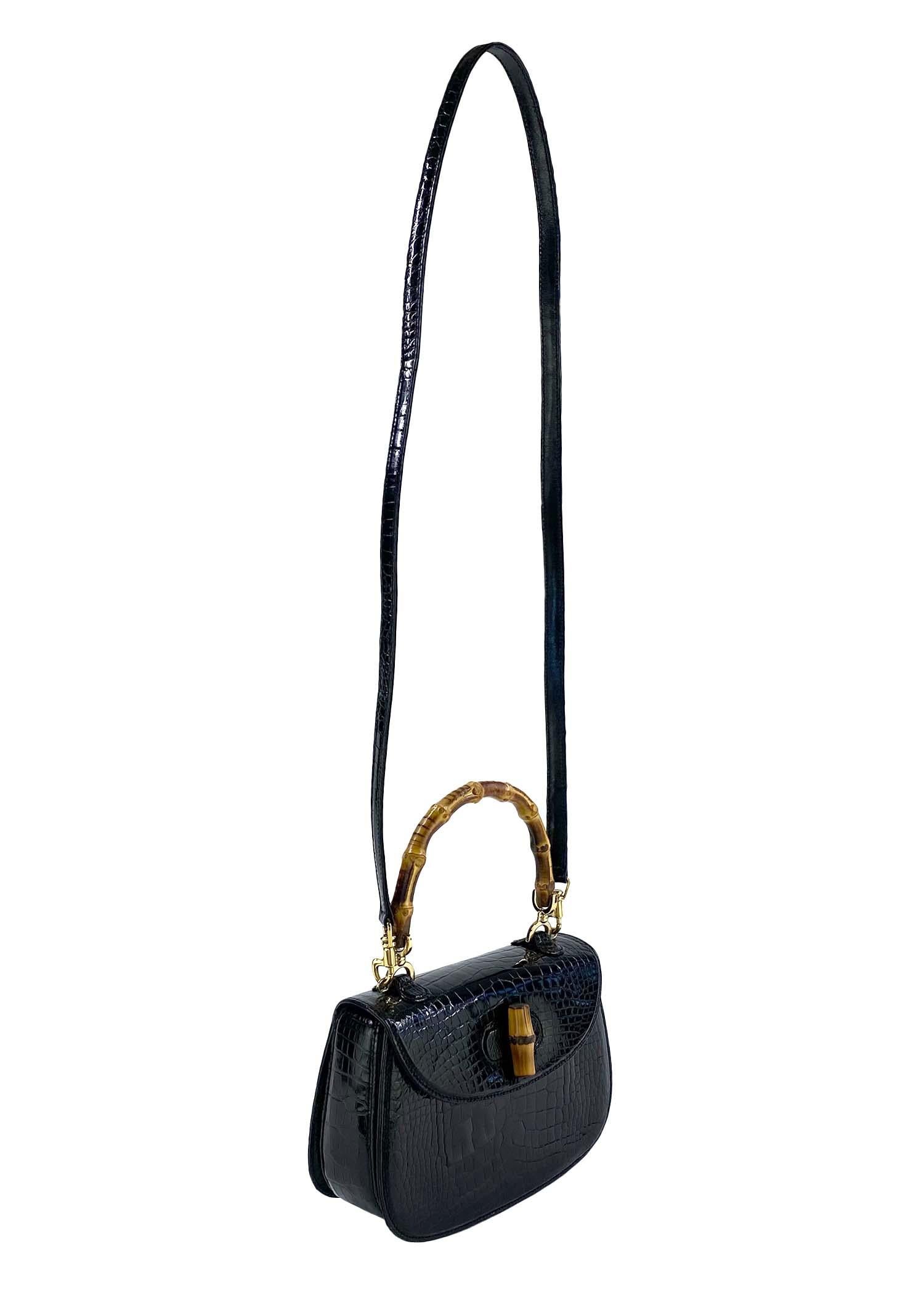 TheRealList presents: a classic Gucci bamboo top handle bag in a rare small size with its original crossbody strap in matching black alligator. The bamboo top handle style first debuted in 1947 and gained popularity after being used by Ingrid