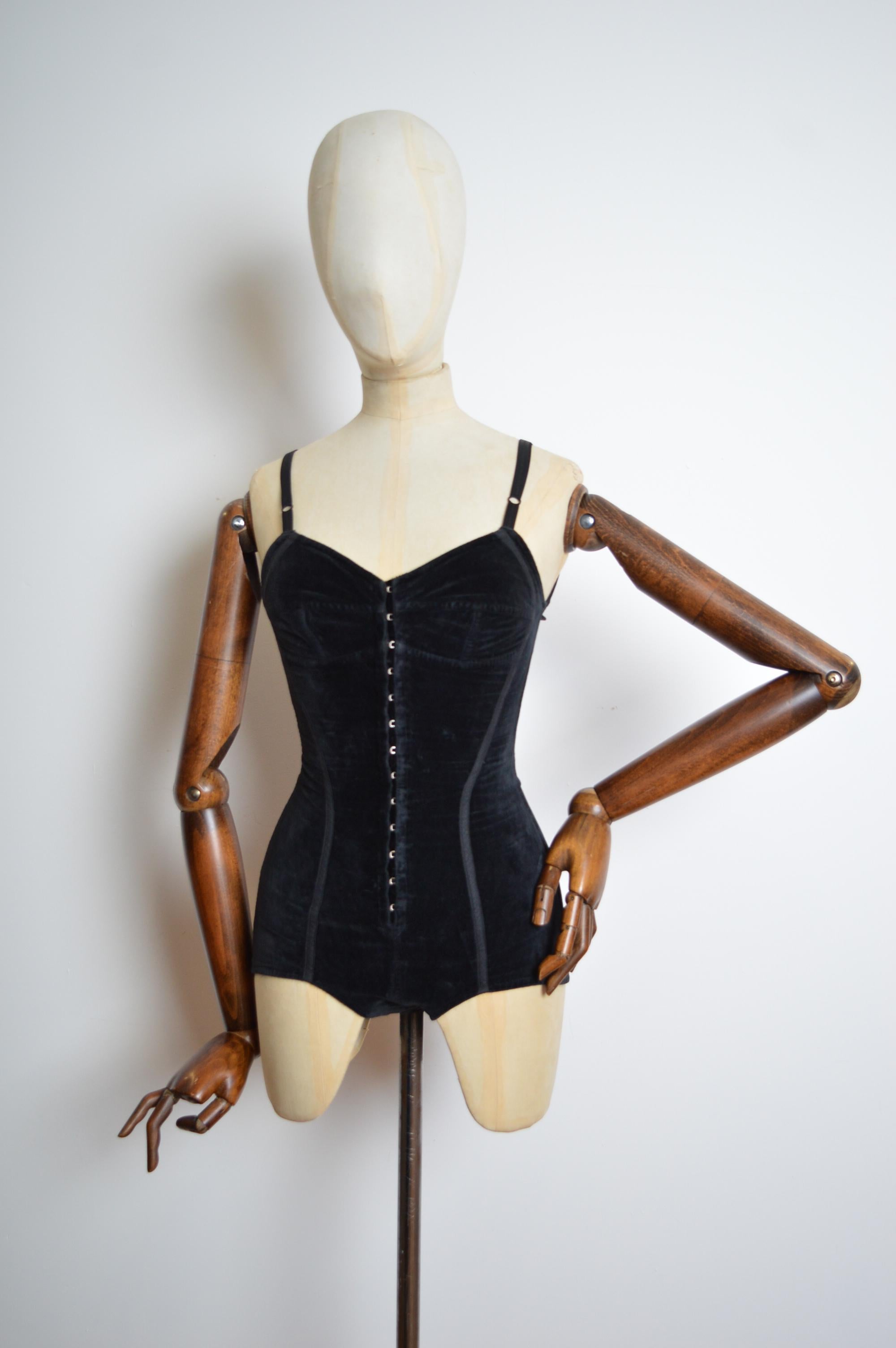 Spring / Summer 1992 Dolce & Gabbana Body suit crafted from black velvet, with a stretchy Lycra blend material on the back. 
Features : Fully adjustable shoulder straps / Farrier hooks down the front centre / Farrier hook crotch closure. 
Size;