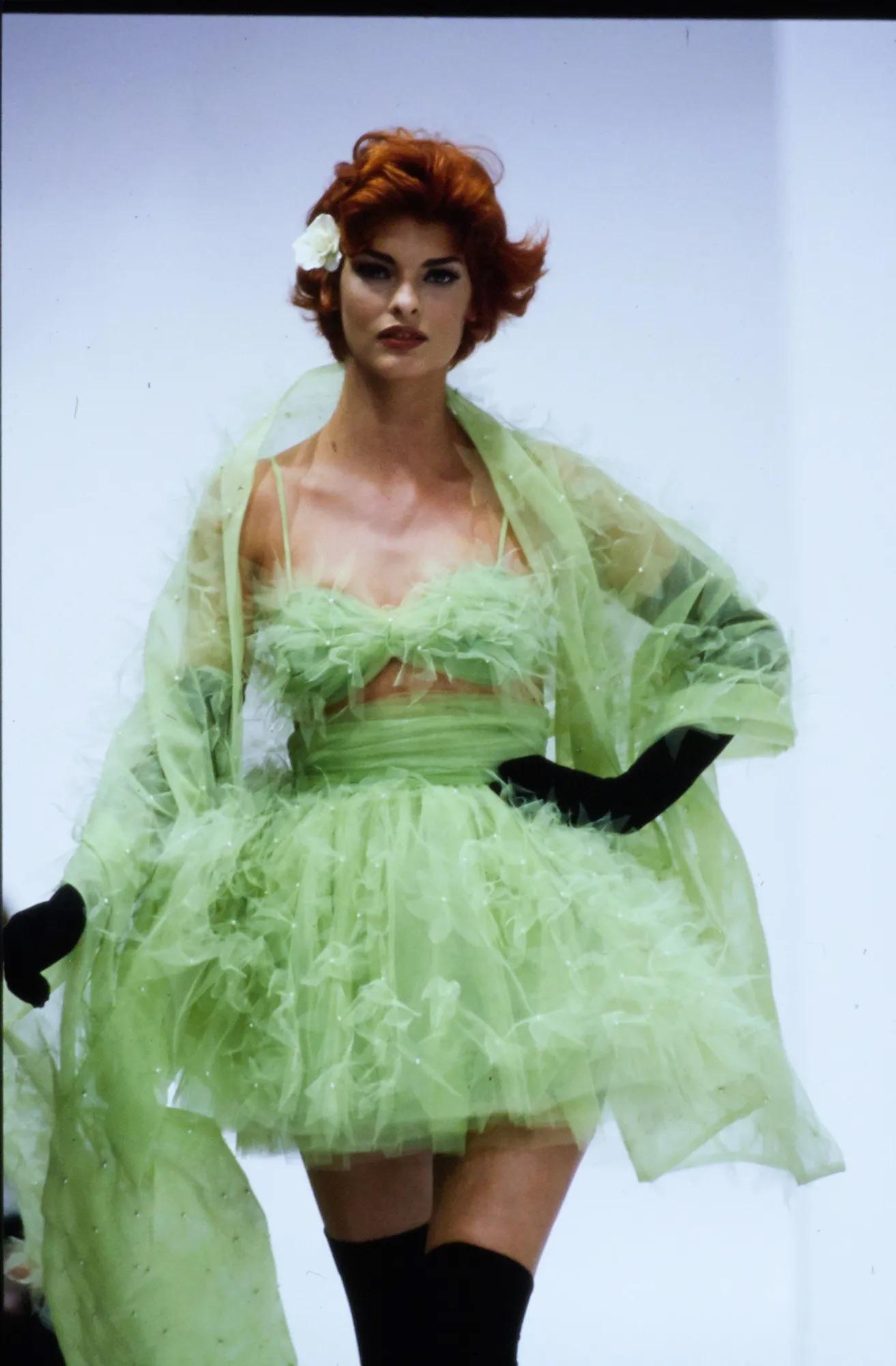 Presenting a lime green tulle bralette from Dolce & Gabbana’s Spring/Summer 1992 collection. Debuting on the season's runway as part of look 24, modeled by Linda Evangelista, this airy piece is constructed from layered ruffled tulle embellished with