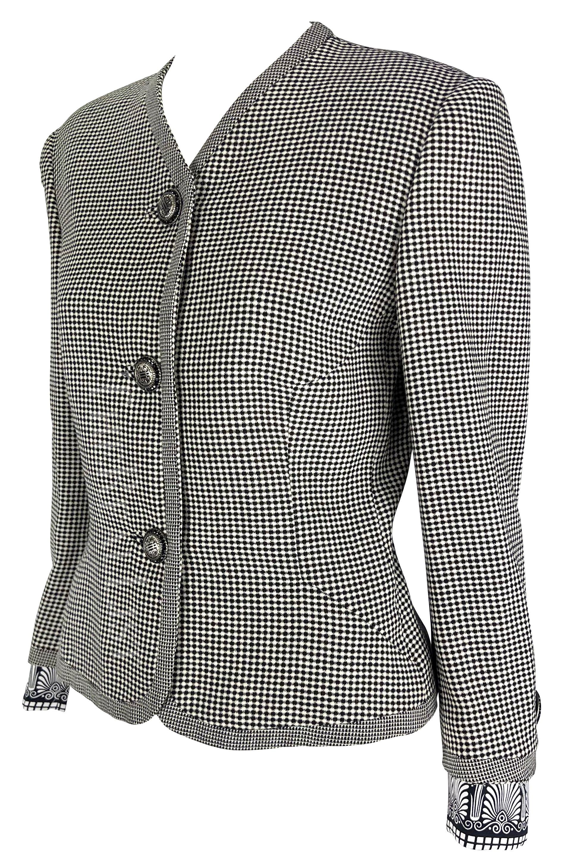 Presenting a chic black and white Gianni Versace checkered jacket, designed by Gianni Versace. From the Spring/Summer 1992 collection, this collarless jacket captures the essence of timeless style. The silver-tone Versace Medusa relief buttons add a