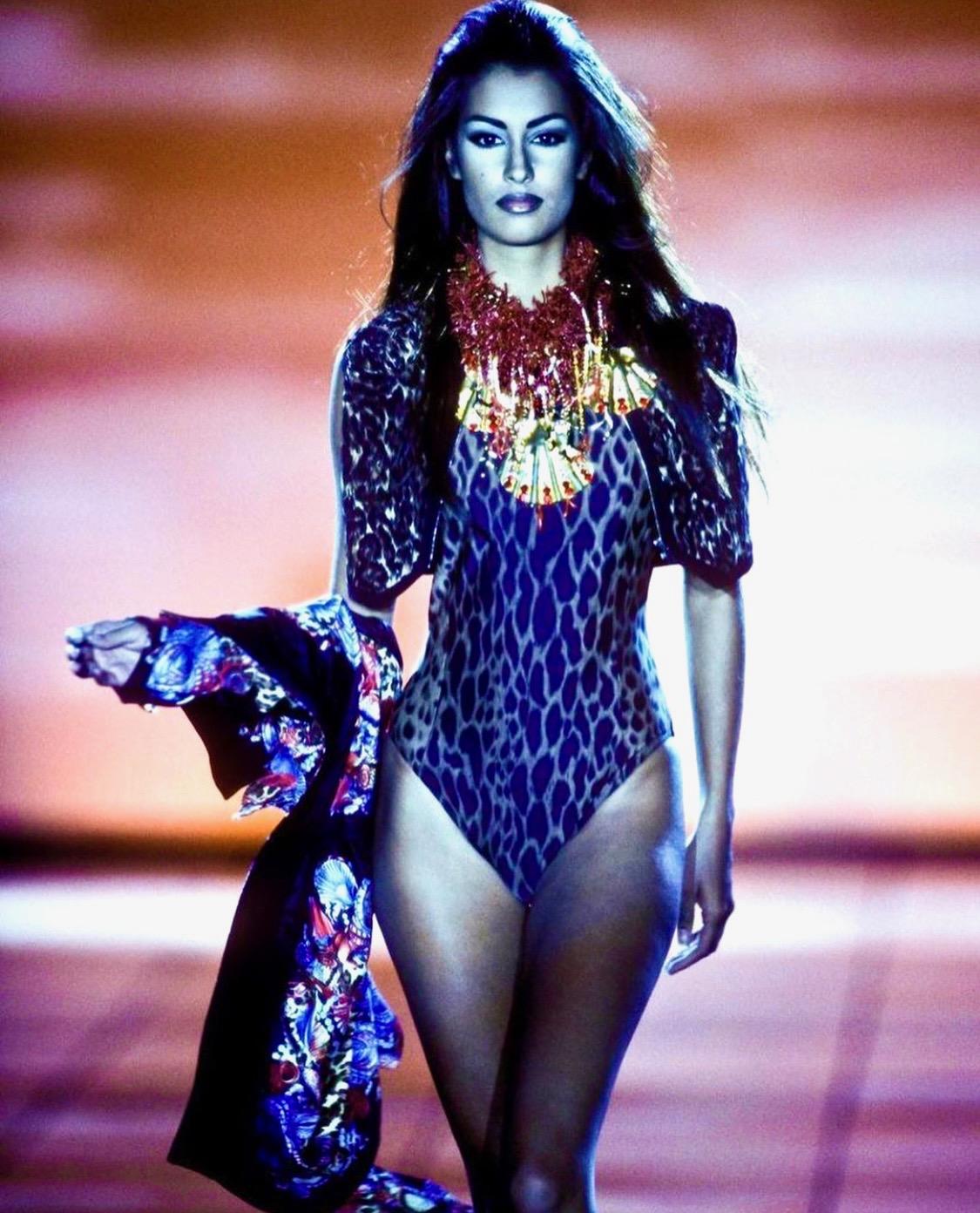 Presenting a beautiful brown leopard print Gianni Versace Couture one-piece bathing suit, designed by Gianni Versace. From the Spring/Summer 1992 collection, this bathing suit debuted as part of look number 26 on Yasmeen Ghauri and is covered in the