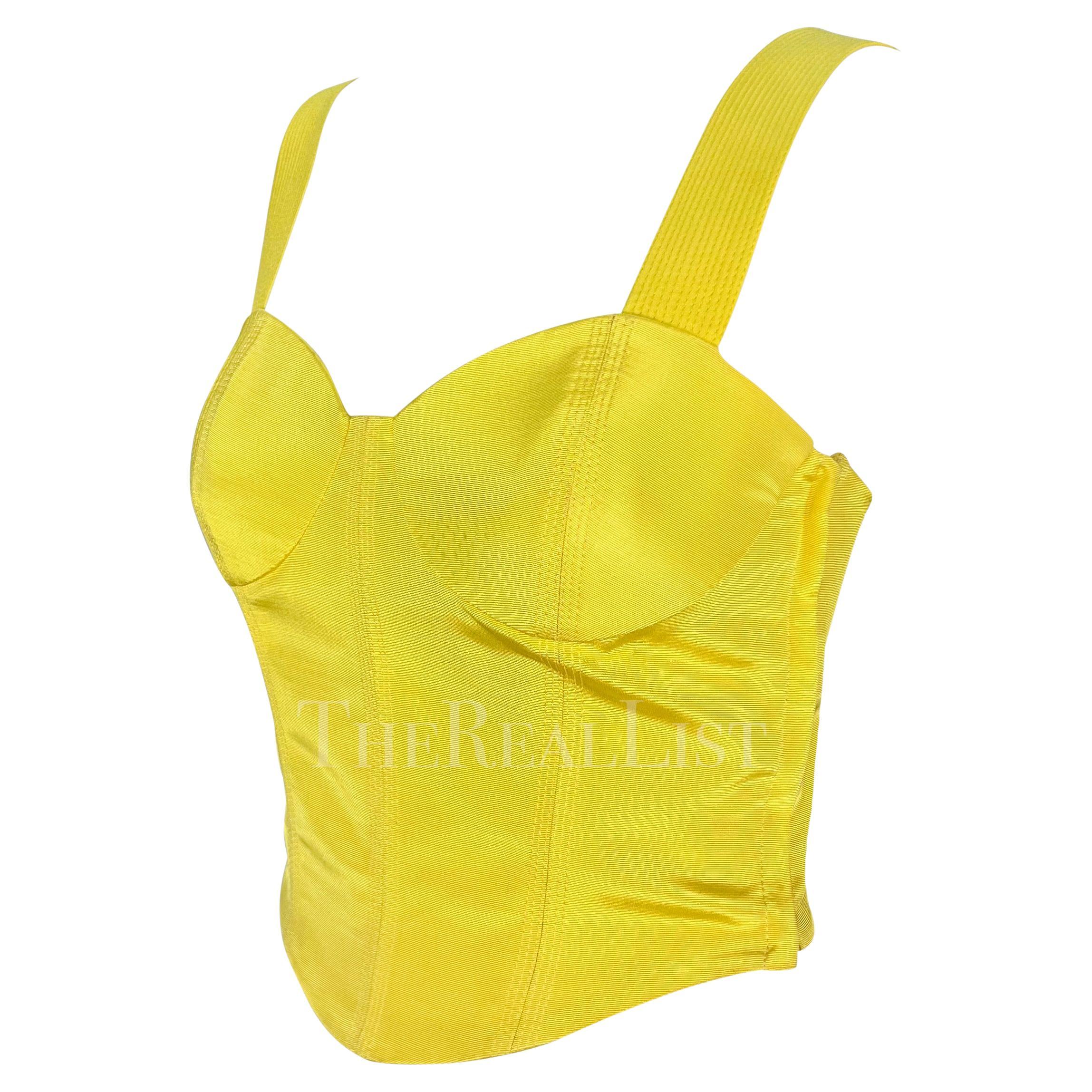 Presenting a chic bright yellow Gianni Versace crop top, designed by Gianni Versace. From the Spring/Summer 1992 collection, this bright yellow top, distinguished by a fitted silhouette, cupped bust, quilted shoulder straps, and a low back, this top