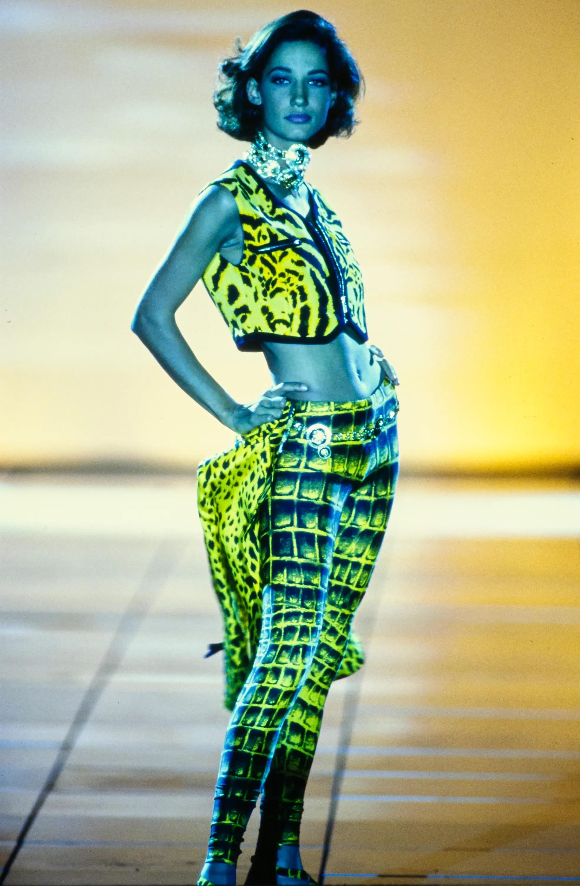 Presenting a pair of yellow crocodile print Gianni Versace tights, designed by Gianni Versace. From the Spring/Summer 1992 collection, these legging pants debuted on the season's runway as part of look 25, modeled by Marpessa Hennink. Also captured