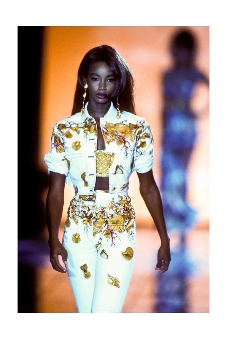 An iconic piece from Gianni Versace's Spring/Summer 1992 collection, this structured bustier features striking gold baroque and colorful seashell and starfish motifs evoking the grandeur of undersea treasures. 
Side hook fastening.
No material tag
