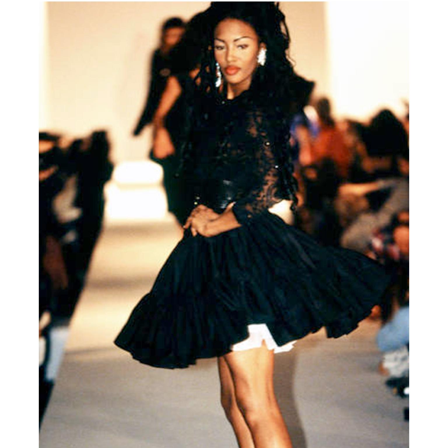 This is a playful tiered ruffle mini skirt designed by Isaac Mizrahi for his Spring/Summer 1992 Collection. This show was filled with this style of short, full skirts, pairing them with puffy crinoline to increase their fullness! This fun black
