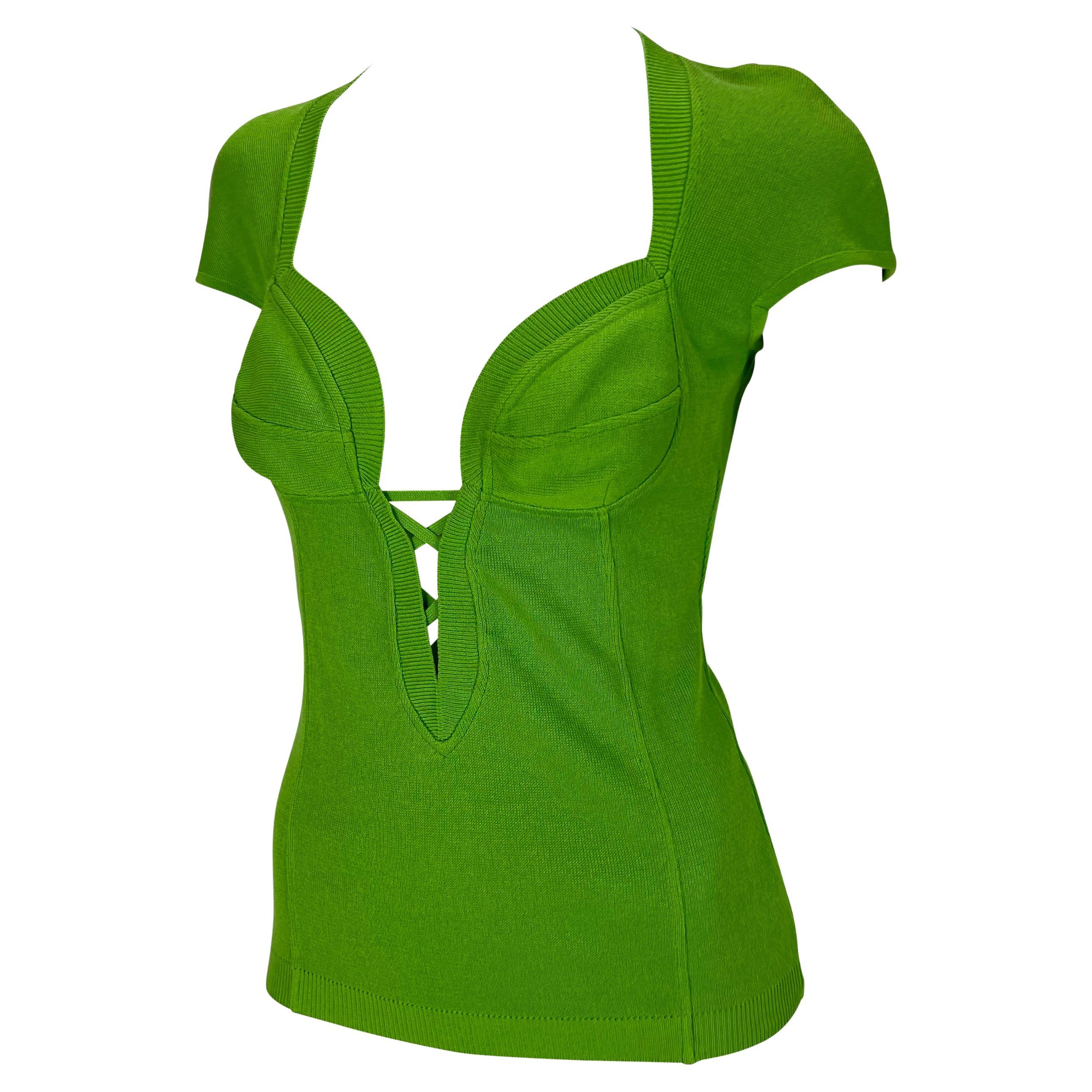 TheRealList presents: a fabulous vibrant green Gianni Versace knit top, designed by Gianni Versace. From the Spring/Summer 1993 collection, this stunning top features a unique and intricate neckline, petal sleeves, and a lace detail below the padded