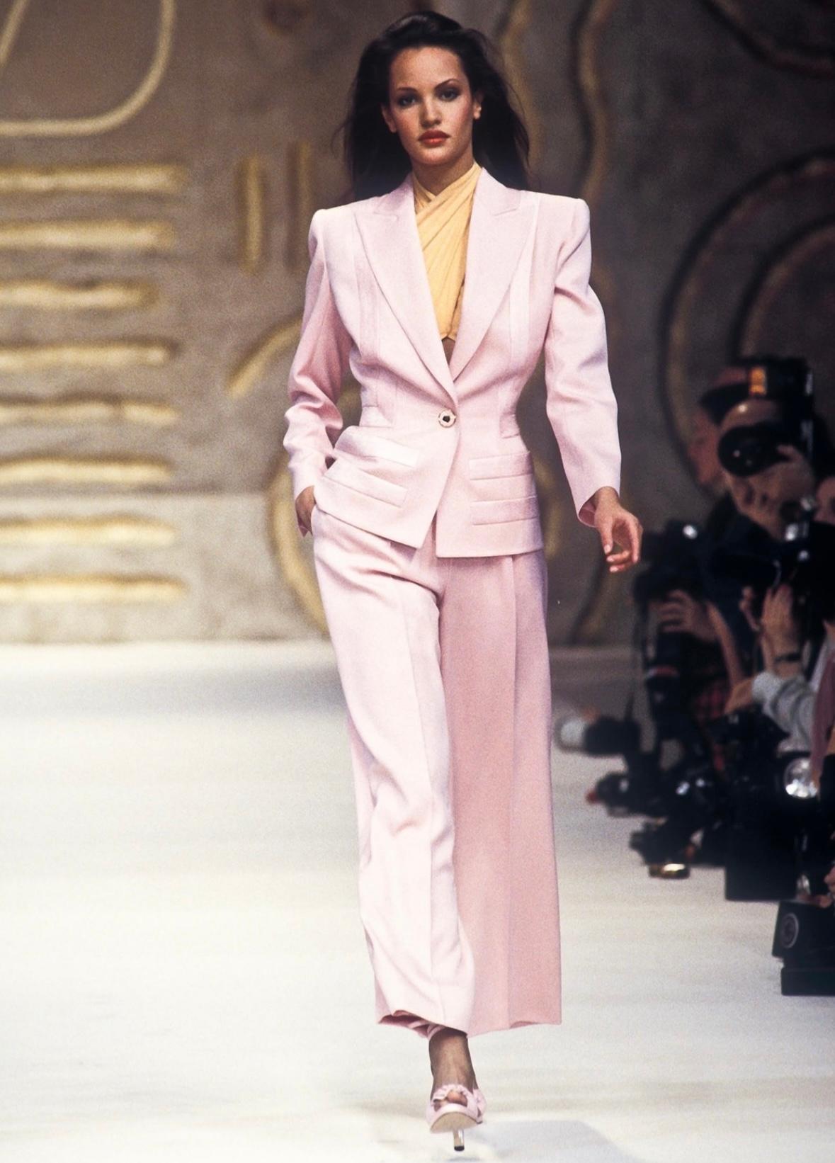 Presenting  a chic light pink Valentino skirt suit. From the Spring/Summer 1993 collection, the jacket from this set debuted on the season's runway. This fitted skirt suit is comprised of a knee-length pencil skirt and matching blazer. The