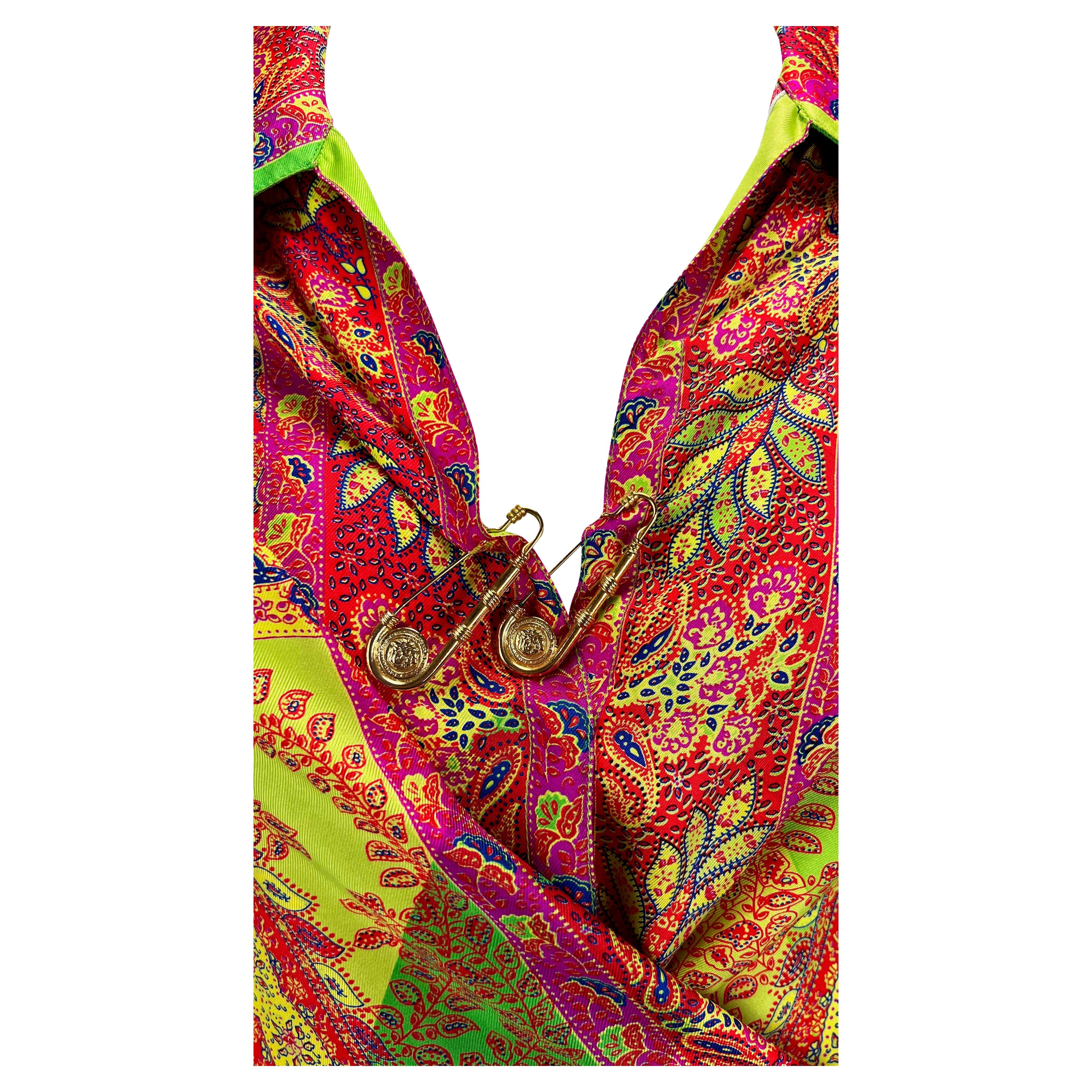 Presenting a gorgeous Bohemian-inspired safety pin Gianni Versace collared shirt, designed by Gianni Versace. From the Spring/Summer 1994 collection, this incredibly vibrant shirt features a floral paisley design, exaggerated collar, and v-neckline.