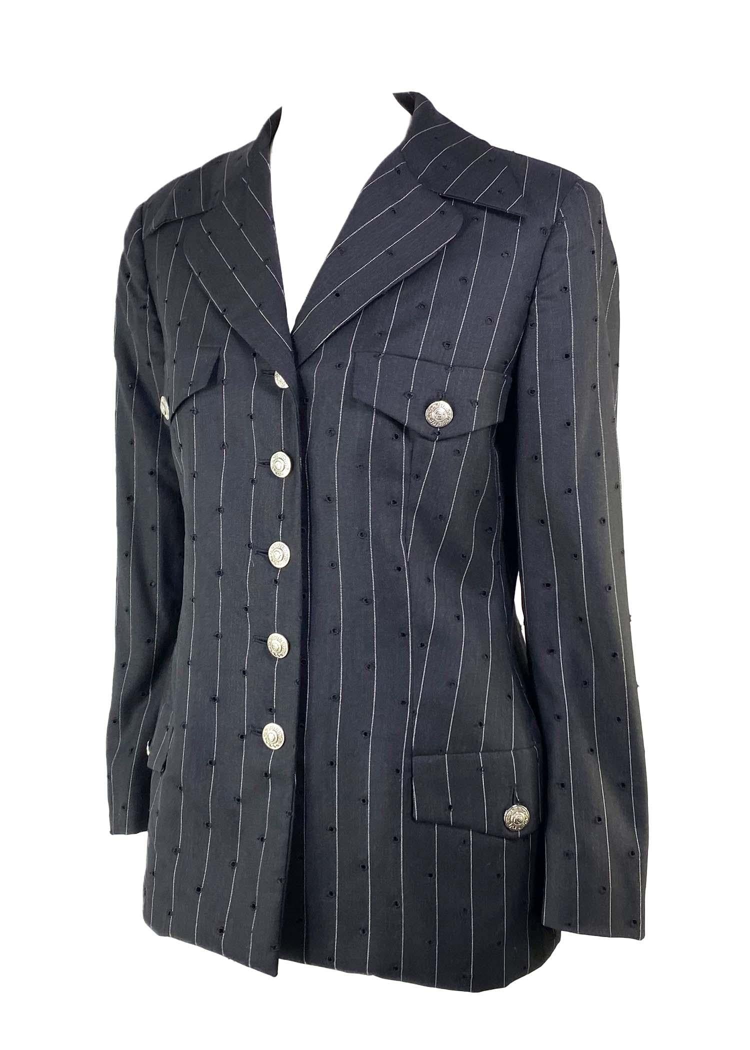Presenting a pinstripe perforated Gianni Versace Couture blazer, designed by Gianni Versace. From the Spring/Summer 1994 collection, this piece features clean cut designs in perforated fabric. This collection is remembered for its punk influences