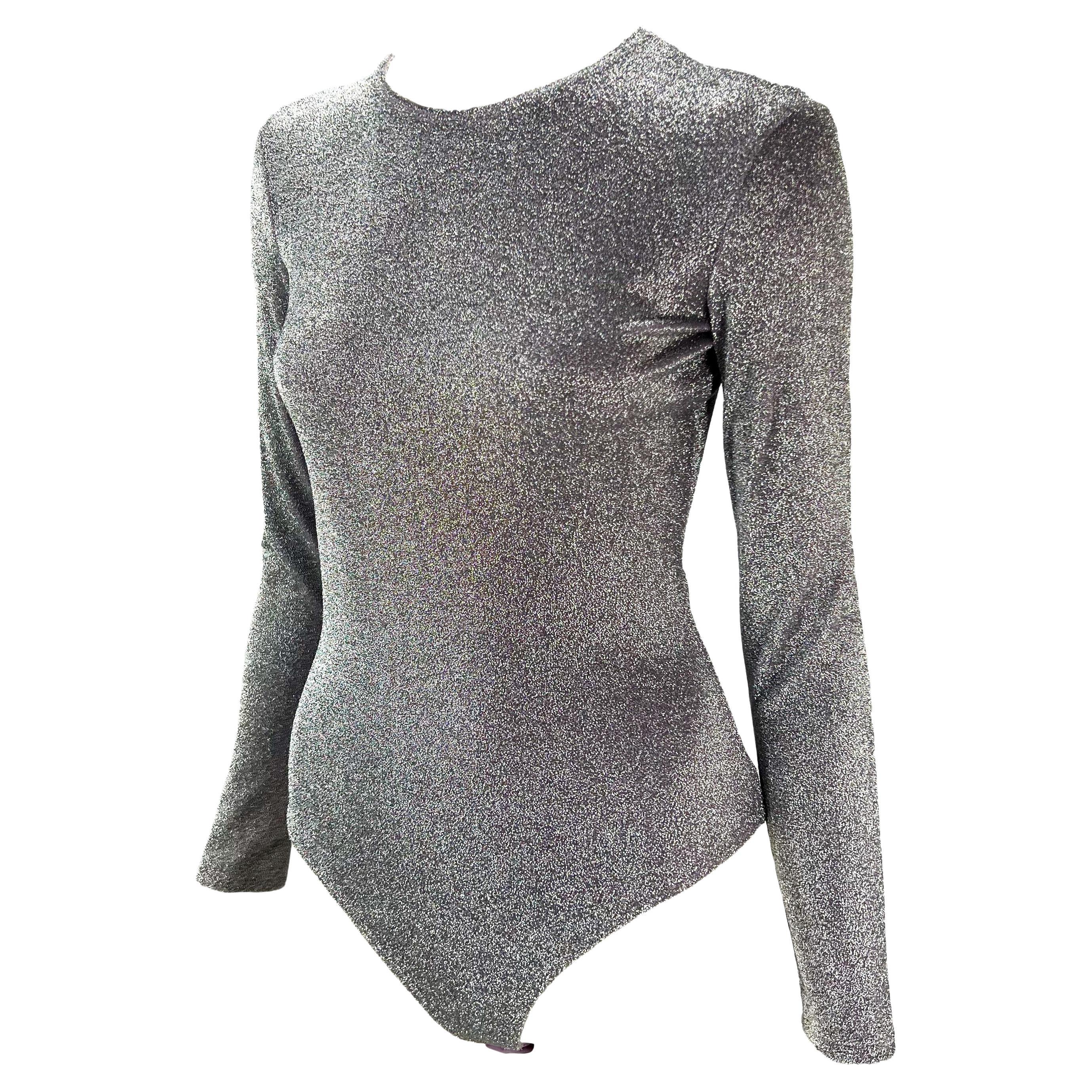 Presenting a silver and periwinkle lurex Gianni Versace Couture bodysuit, designed by Gianni Versace. From the Spring/Summer 1994 collection, this amazing one-piece features long sleeves and a wide neckline. Shimmer and shine in this rare piece of