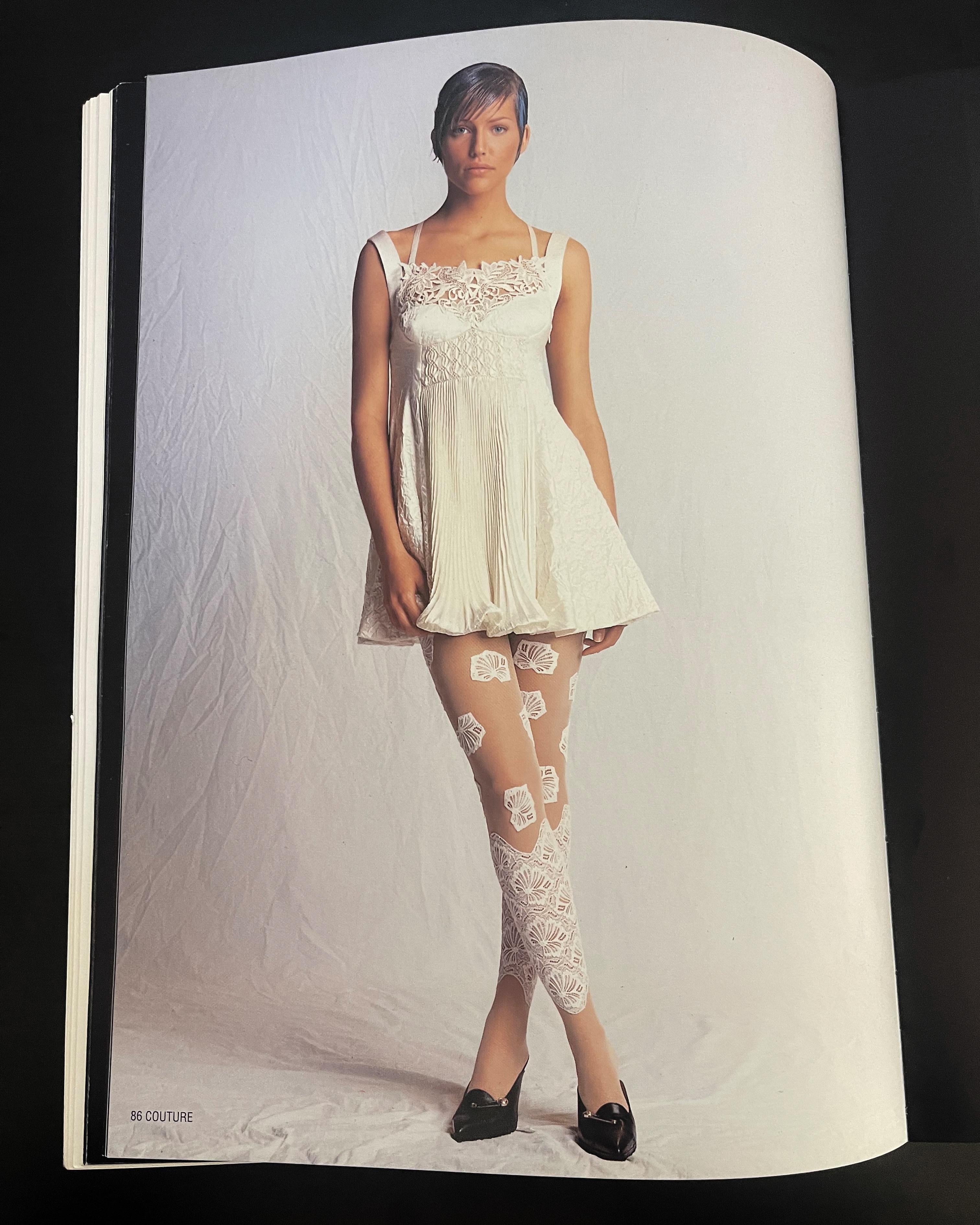 S/S 1994 Gianni Versace ecru micro mini slip dress. Silk and lace off-white dress with full front pleated skirt. Fitted waist and honeycomb under-bust structure with embellished mini white beaded details. Concealed side zip closure and nude silk