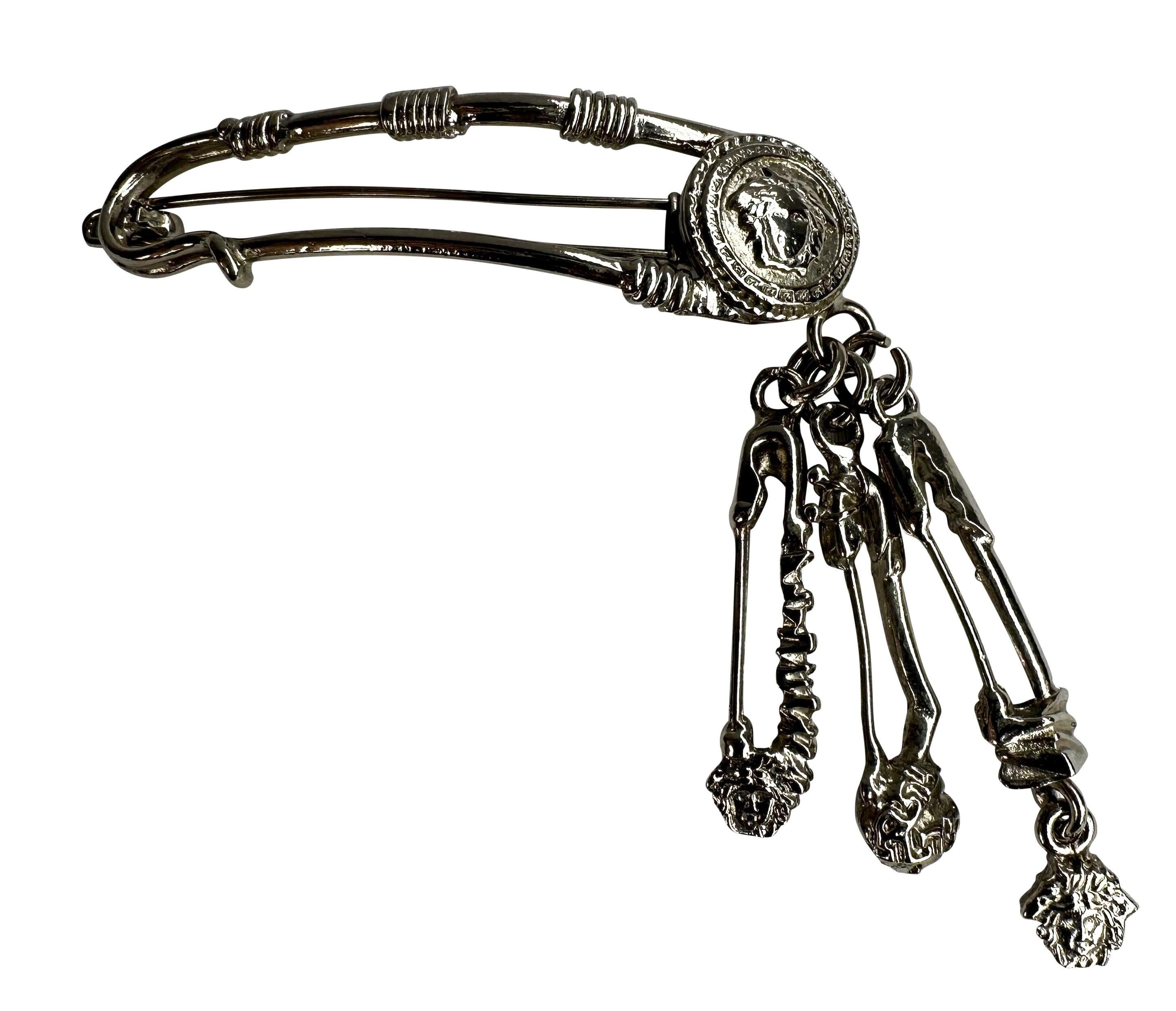 Presenting an incredible silver-tone Gianni Versace Medusa hair clip, designed by Gianni Versace. From the Spring/Summer 1994 collection, this oversized safety pin barrette is covered in Versace Medusa logos and is made complete with additional