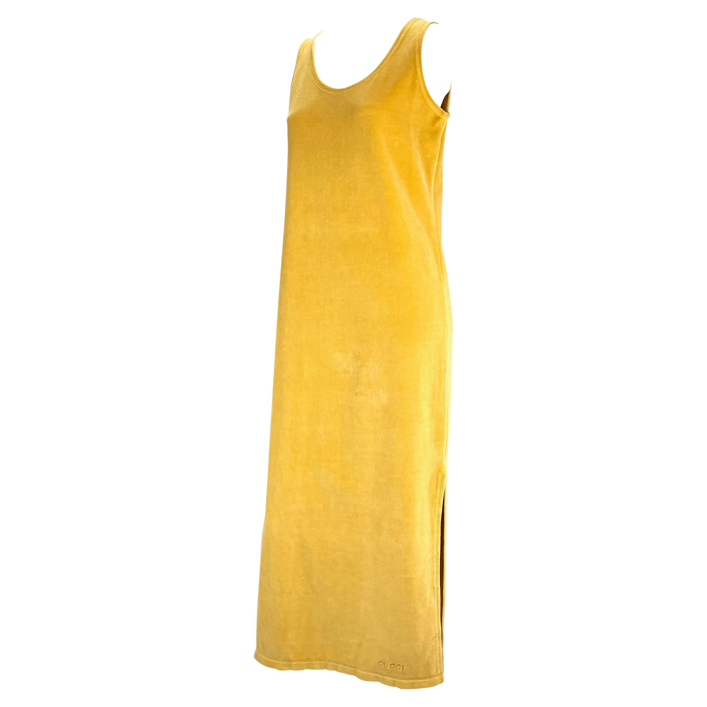 Presenting a vintage marigold Gucci dress. From the Spring/Summer 1994 collection, this velvet terry cloth full length column dress features a scoop neckline with small slits on either side of the skirt. The perfect casual dress or pool cover up,