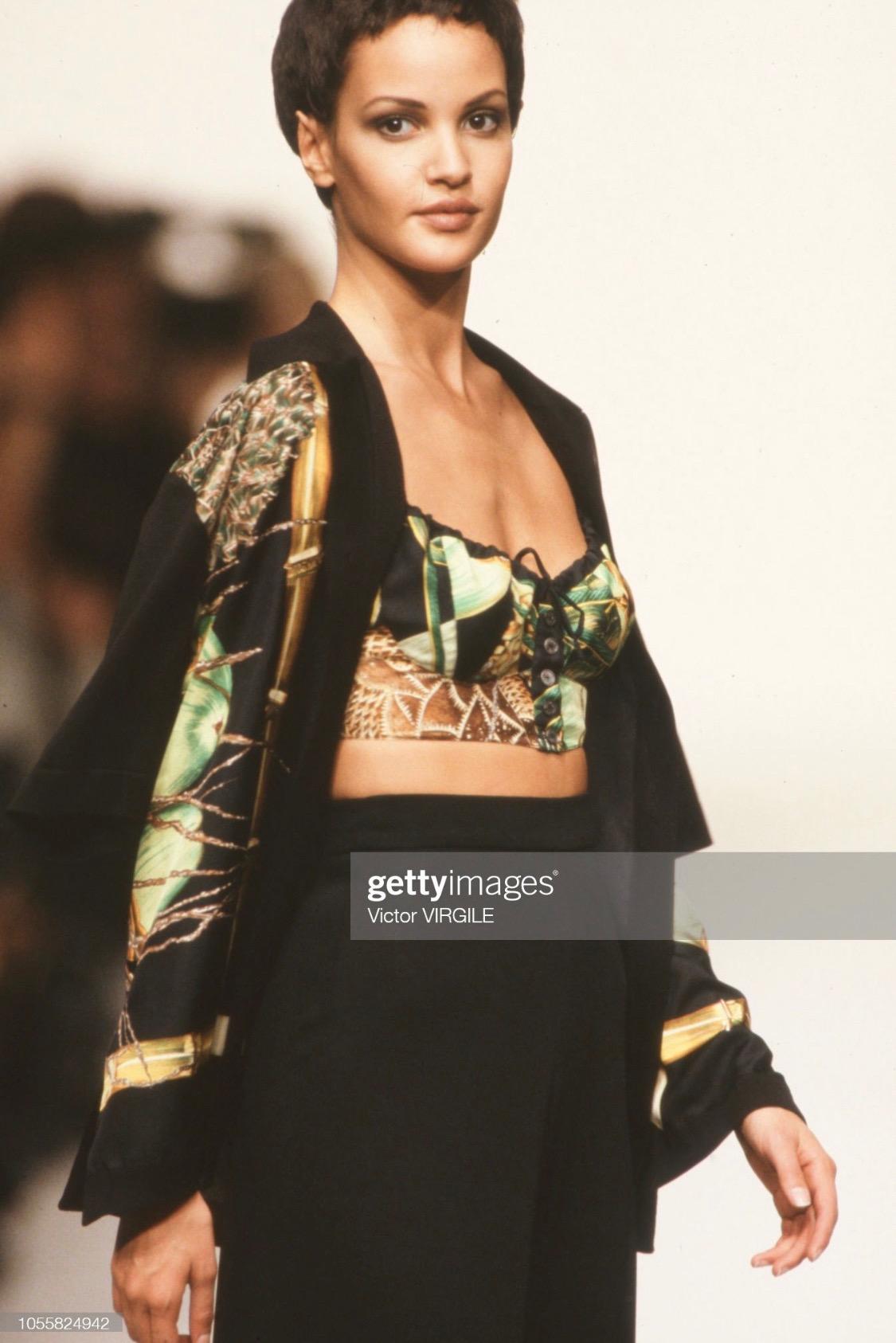 Presenting a beautiful 'Creole Garden' jungle print Hermès bralette crop top and silk shirt set. From the Spring/Summer 1994 collection, this set debuted on the season's runway. The crop top from this beautiful set features a Hermès branded button