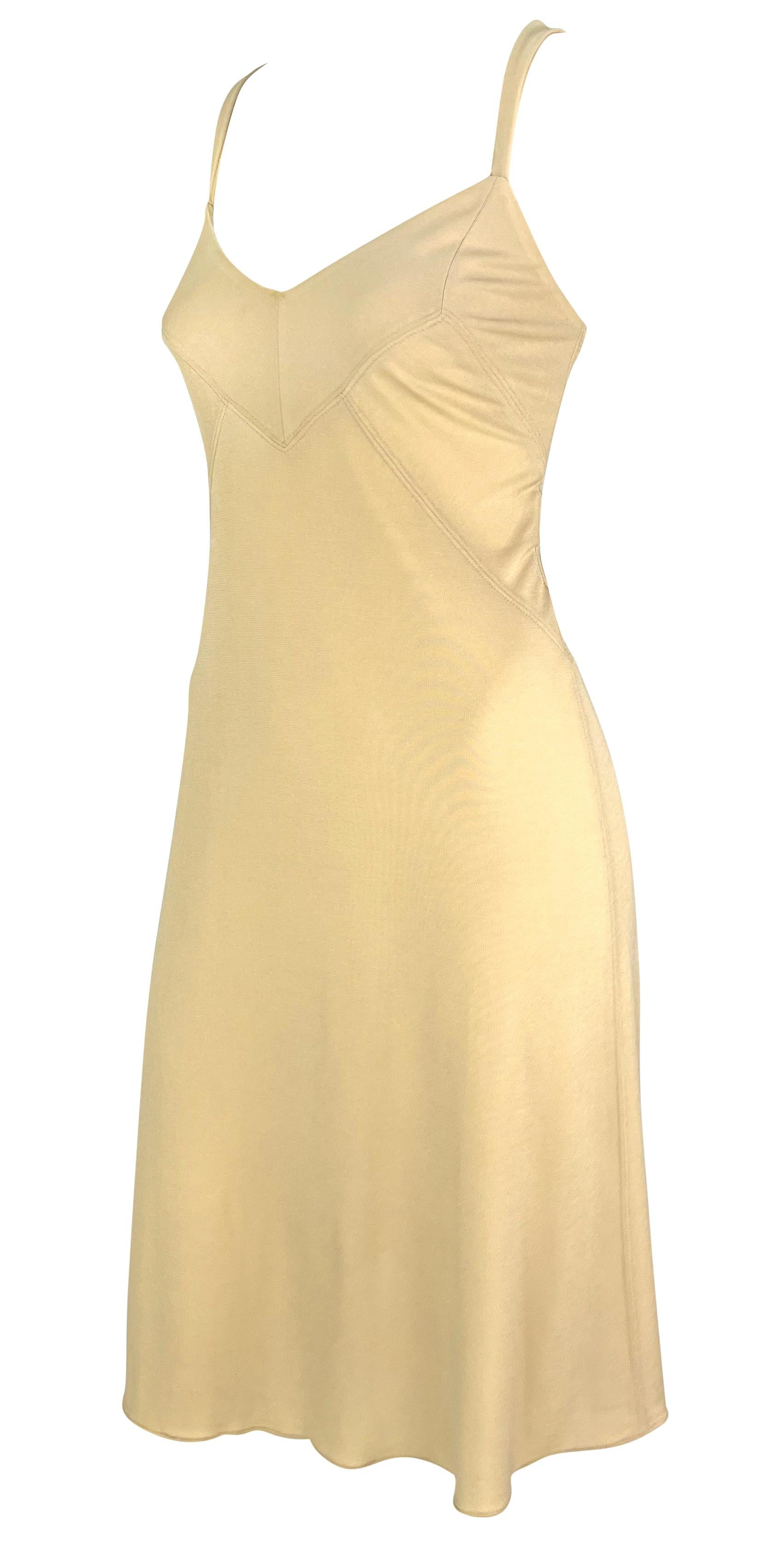 This beige slip dress from Donna Karan's Spring/Summer 1995 collection features a stretch bodycon fit with panel detailing at the bust. The dress is complete with thin shoulder straps and a flare cut. 

Approximate measurements:
Size - US6, IT4,