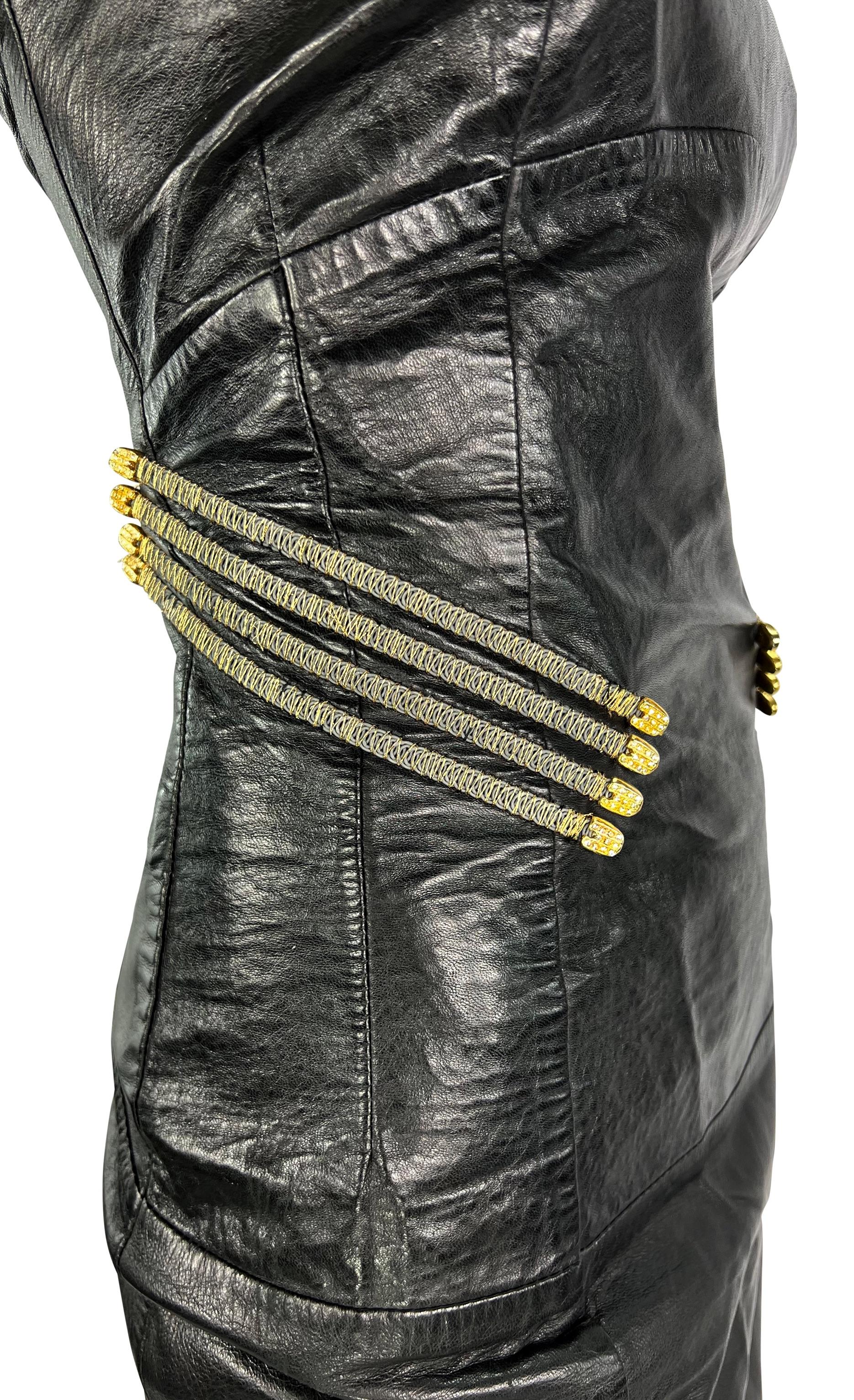 This fabulous Gianfranco Ferre leather mini dress is constructed entirely of black leather and features gold-tone accents on either side. This form-fitting slip-style mini dress from the Spring/Summer 1995 collection features a square neckline,