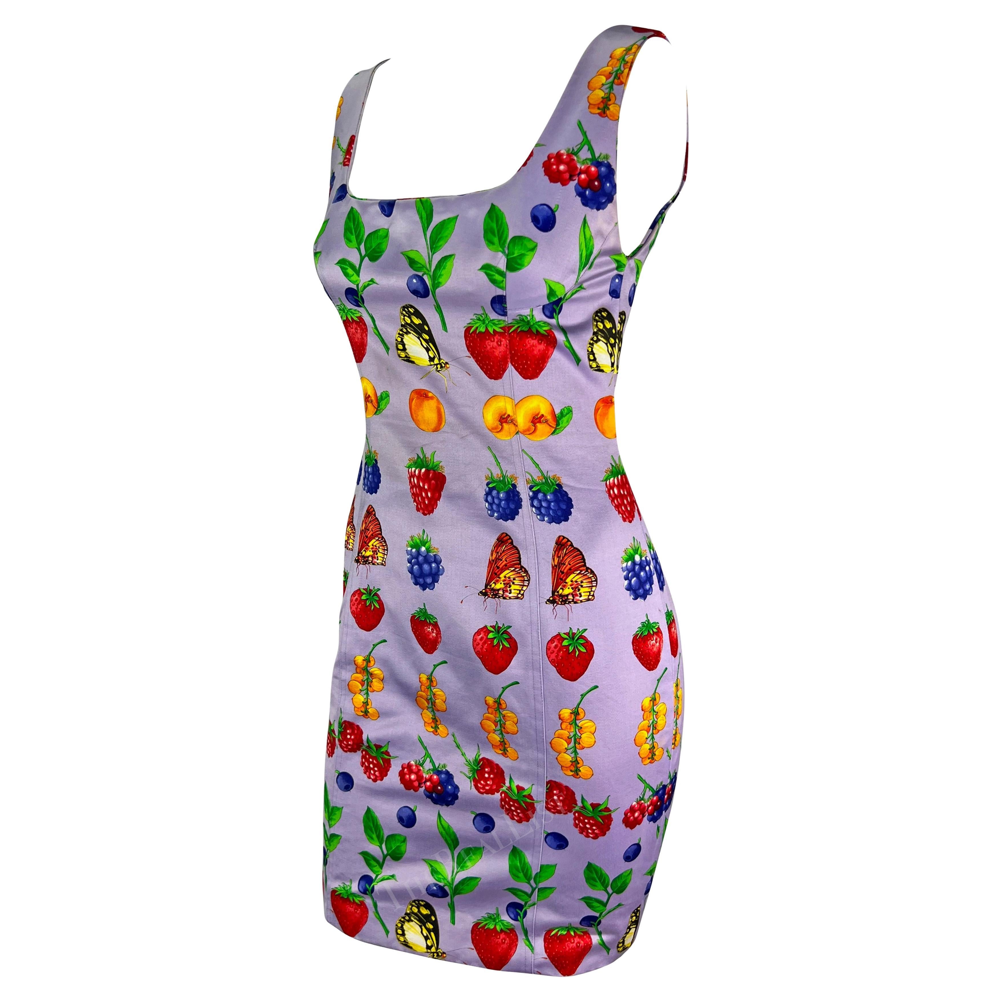 Presenting a fabulous lavender Gianni Versace fruit motif mini dress, designed by Gianni Versace. From the Spring/Summer 1995 collection, this dress is covered in a vibrant fruit and butterfly print. The sleeveless dress features a sheath cut and a