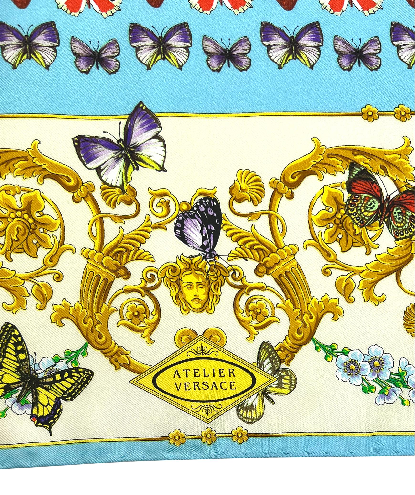 This Gianni Versace headscarf from the Spring/Summer 1995 collection features a vibrant butterfly print set against a light blue background with ornate baroque patterns. Crafted from silk, this square scarf beautifully combines intricate butterfly