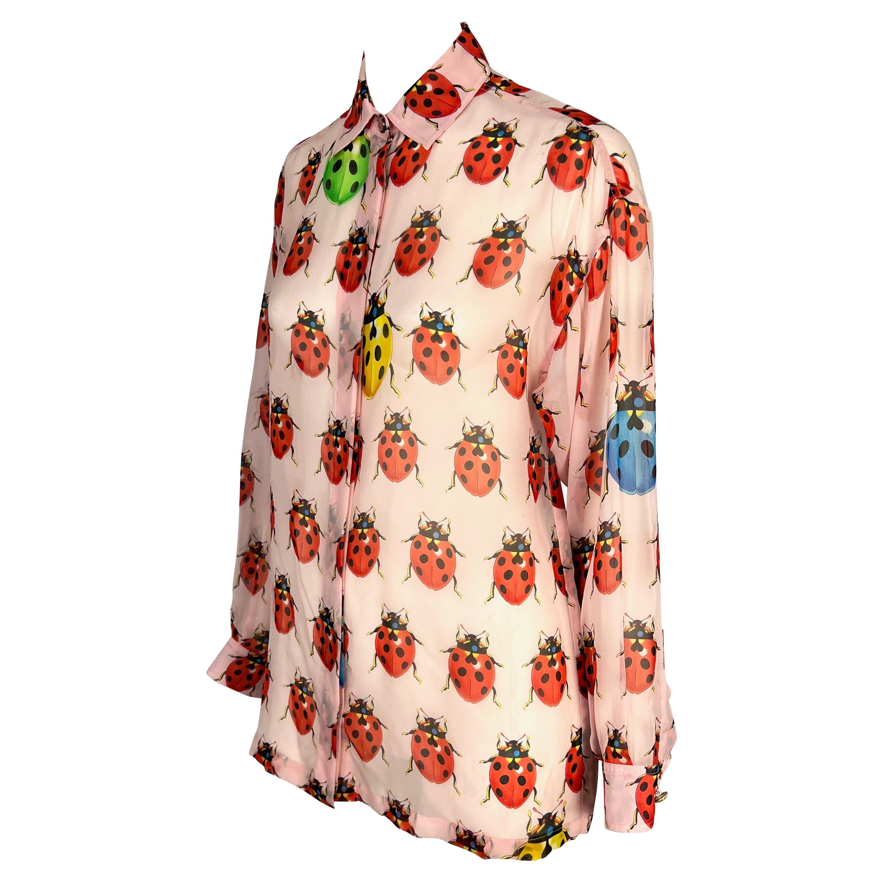 Presenting a light pink ladybug sheer Gianni Versace Couture collared shirt, designed by Gianni Versace. From the Spring/Summer 1995, this ladybug print debuted on the season's runway and quickly became a beloved pattern by the fashion house,