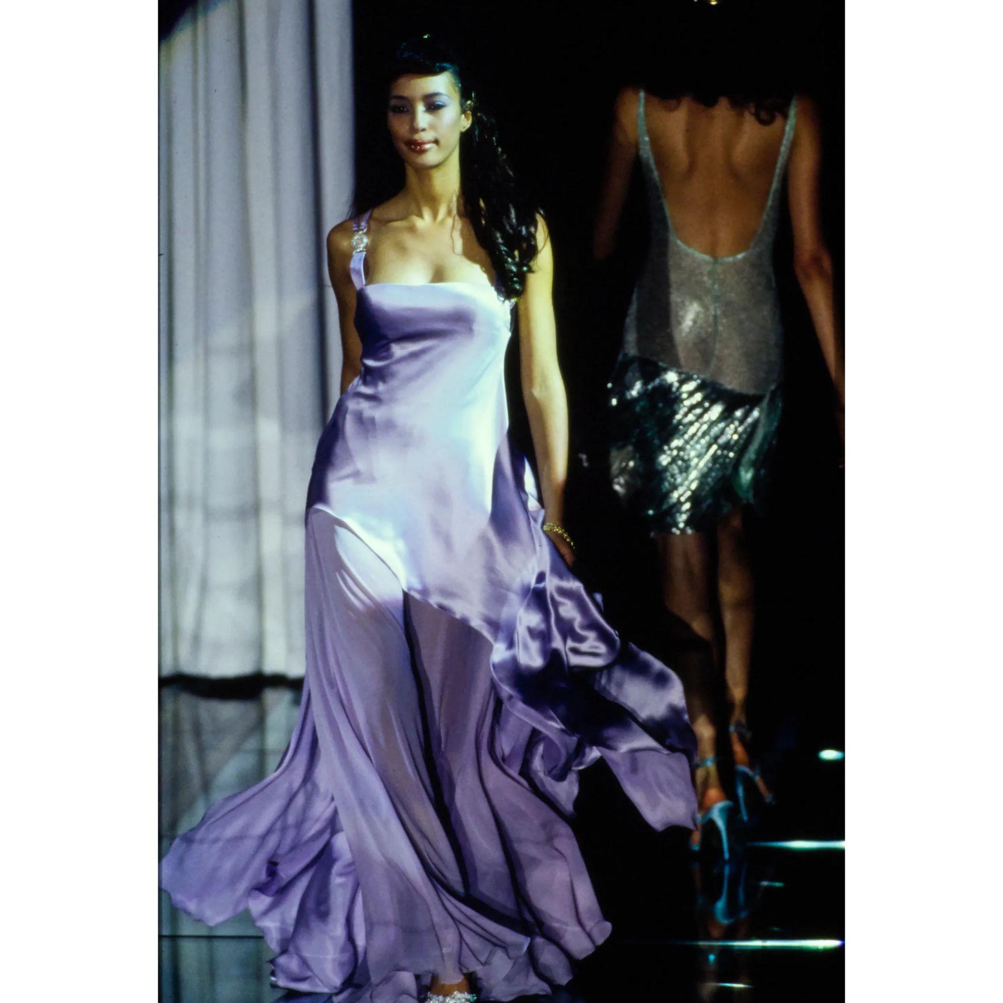 S/S 1995 Gianni Versace lavender purple silk asymmetrical drape gown. Features signature Medusa head racerback straps, built-in corset and side zip closure. Silk satin gown with asymmetrical open silk chiffon flowing hemline. As seen on the runway