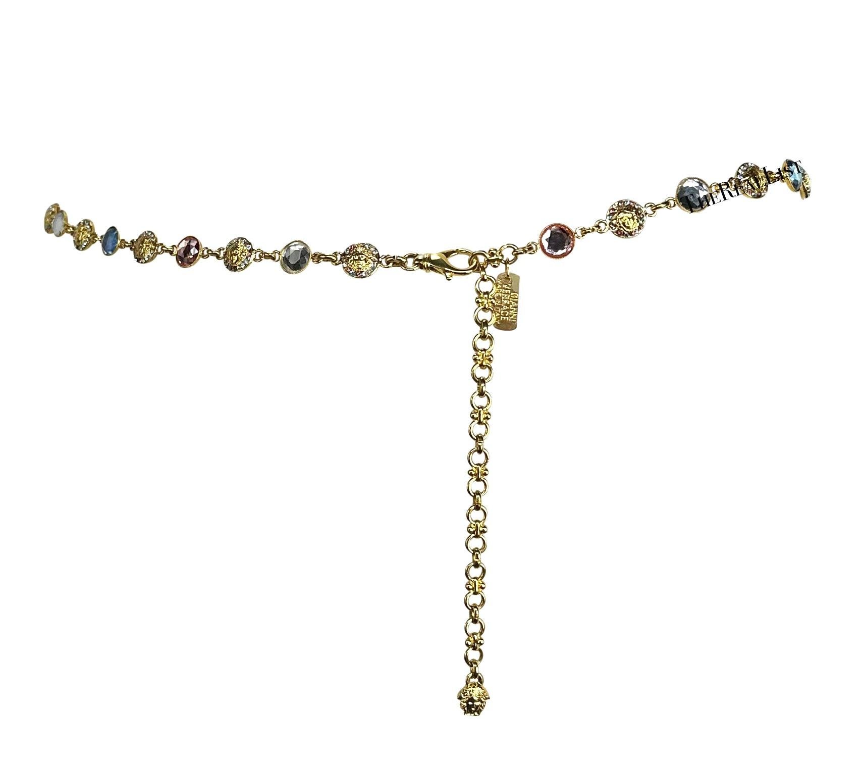 Presenting an incredible thin gold-tone Gianni Versace chain belt, designed by Gianni Versace. From the Spring/Summer 1995 collection, this chic belt is constructed with pink, blue, and clear rhinestone links broken up with Versace Medusa logo