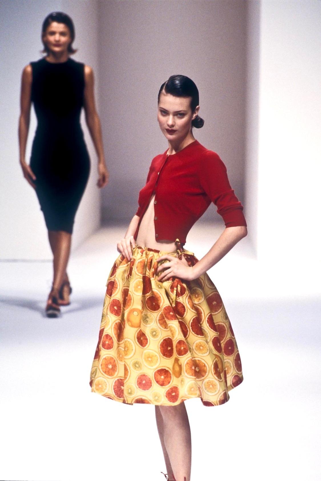 Presenting a bright silk satin skirt designed by Tom Ford for his first collection with the house of Gucci, Spring/Summer 1995. Debuting on the runway on Shalom Harlow, this gorgeous piece features tie closures at each hip for an adjustable fit and