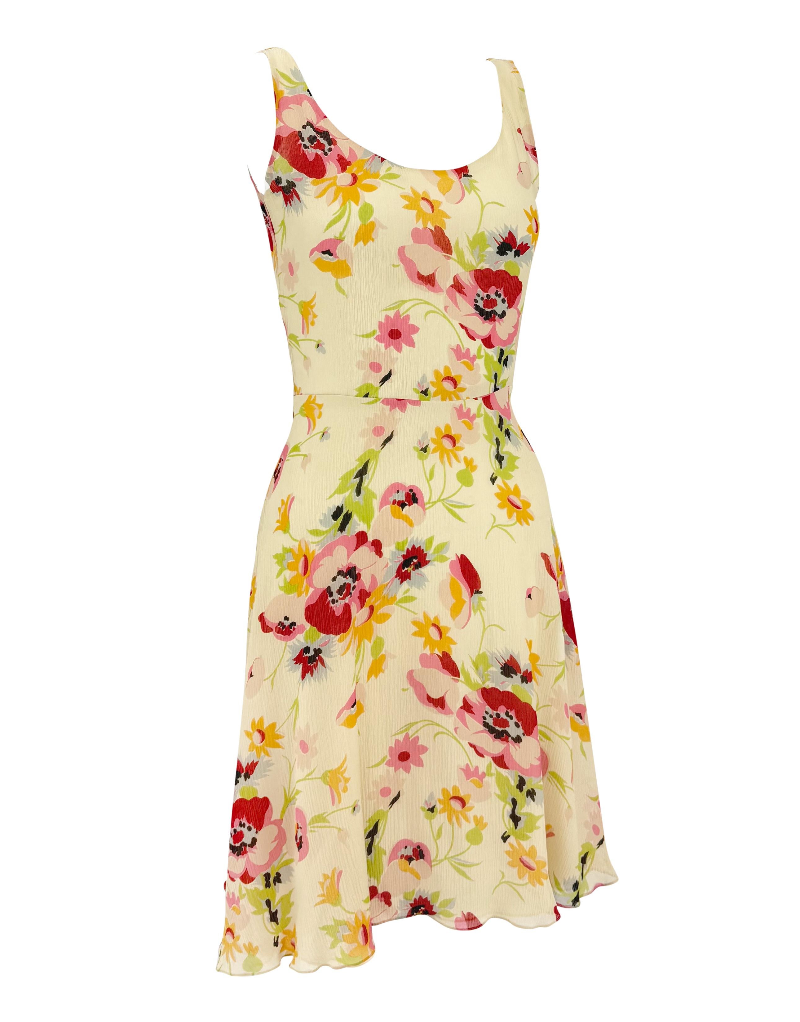 From Ralph Lauren’s Spring/Summer 1995 collection, this off-white crepe silk mini dress features a vibrant floral print in shades of pink, red, and yellow. The silhouette is defined by a scoop neckline, fitted bodice, and softly flared skirt. A