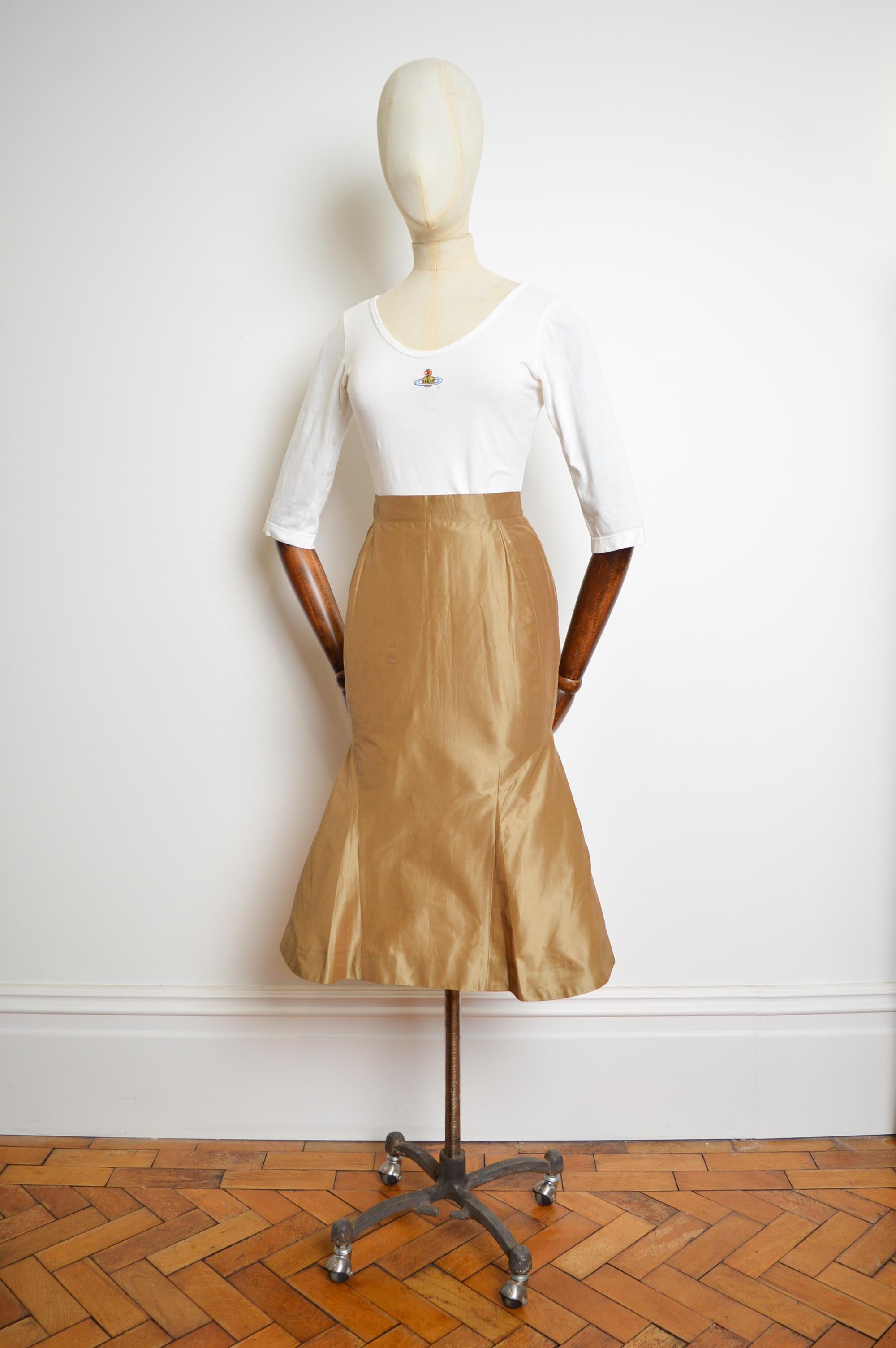 A soft Gold fishtailed pencil skirt from the Spring/ Summer 1995 'Erotic Zones' collection by Vivienne Westwood.

MADE IN ITALY.

The skirt is crafted from a powdered gold cloth with a high waisted figure-cinching silhouette, signature amber