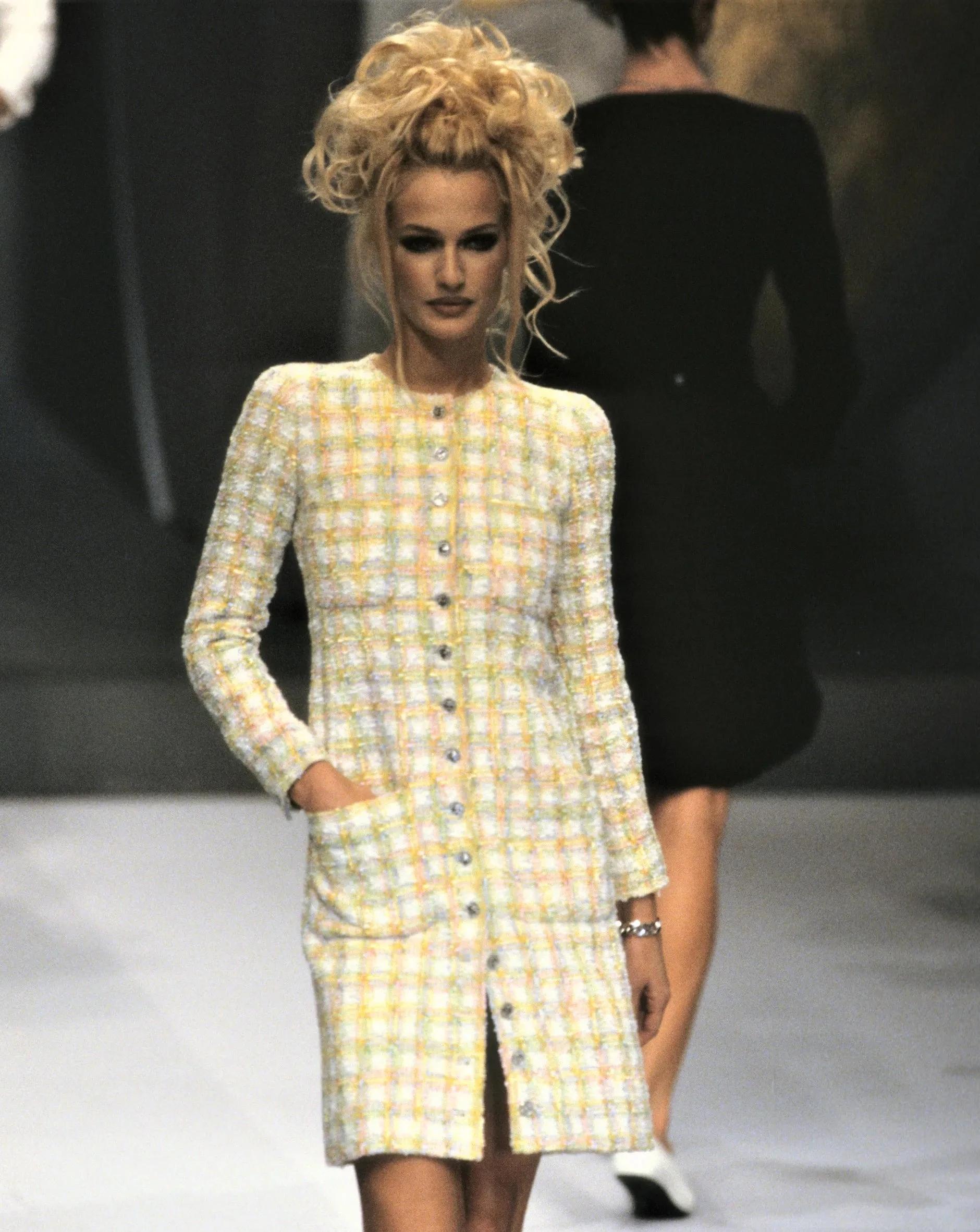 S/S 1996 Chanel by Karl Lagerfeld pastel yellow tweed mini blazer dress with pink and green contrast accents throughout. Button-up long blazer / dress with functional flap pockets at bust and hips. Silver tone buttons feature coin details. Fabric