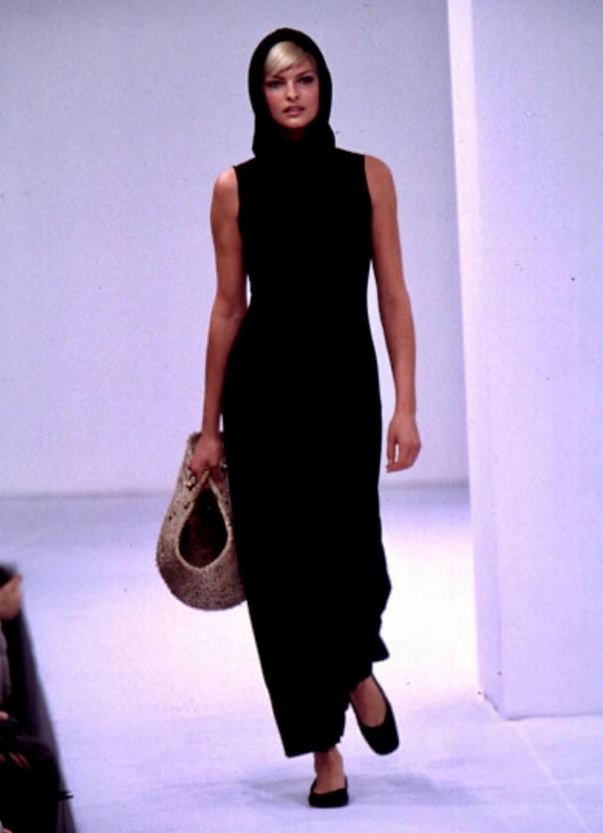 Presenting a fabulous hooded Dolce and Gabbana maxi dress. From the Spring/Summer 1996 collection, this high-slit dress debuted on Linda Evangelista as the opening look on the season’s runway. The idea for this collection was found in timeless style