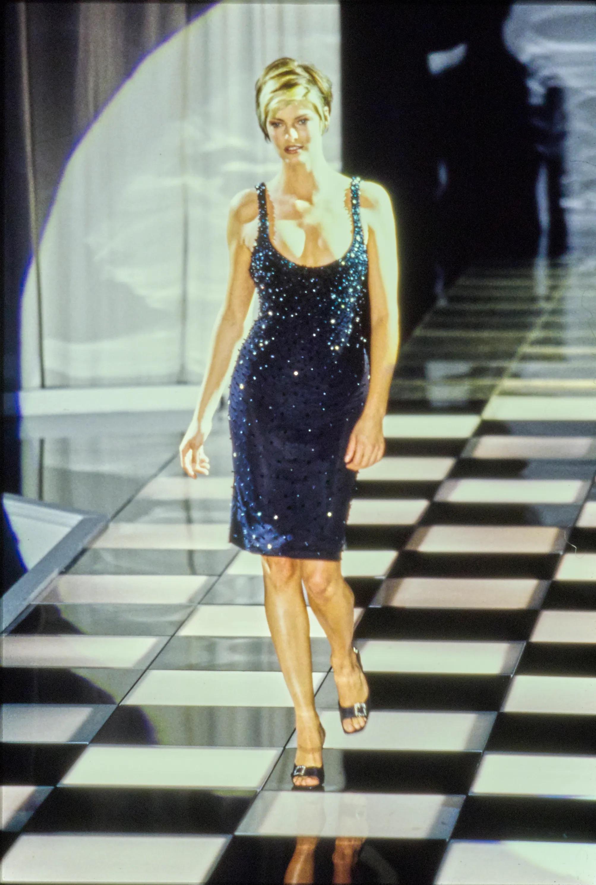 Presenting a fabulous black body con Gianni Versace mini dress, designed by Gianni Versace. From the Spring/Summer 1996 collection, this dress debuted on the season's runway as look 52, modeled by Linda Evangelista. This incredibly chic LBD is
