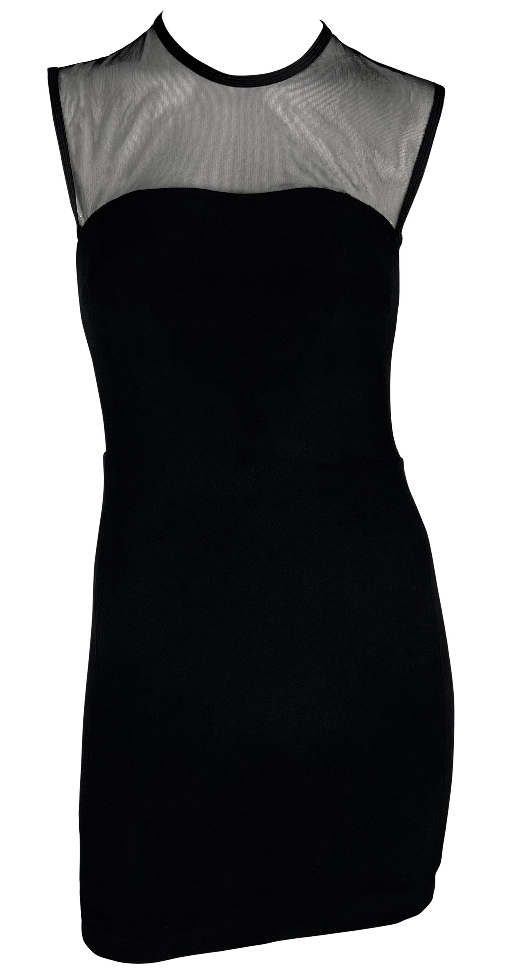 Gianni Versace designed this black mod mini dress for his  Spring/Summer 1996 Gianni Versace collection. This fabulous short dress features a mesh detail above that extends under each arm and to the upper back. Classic yet sexy and chic, this mod