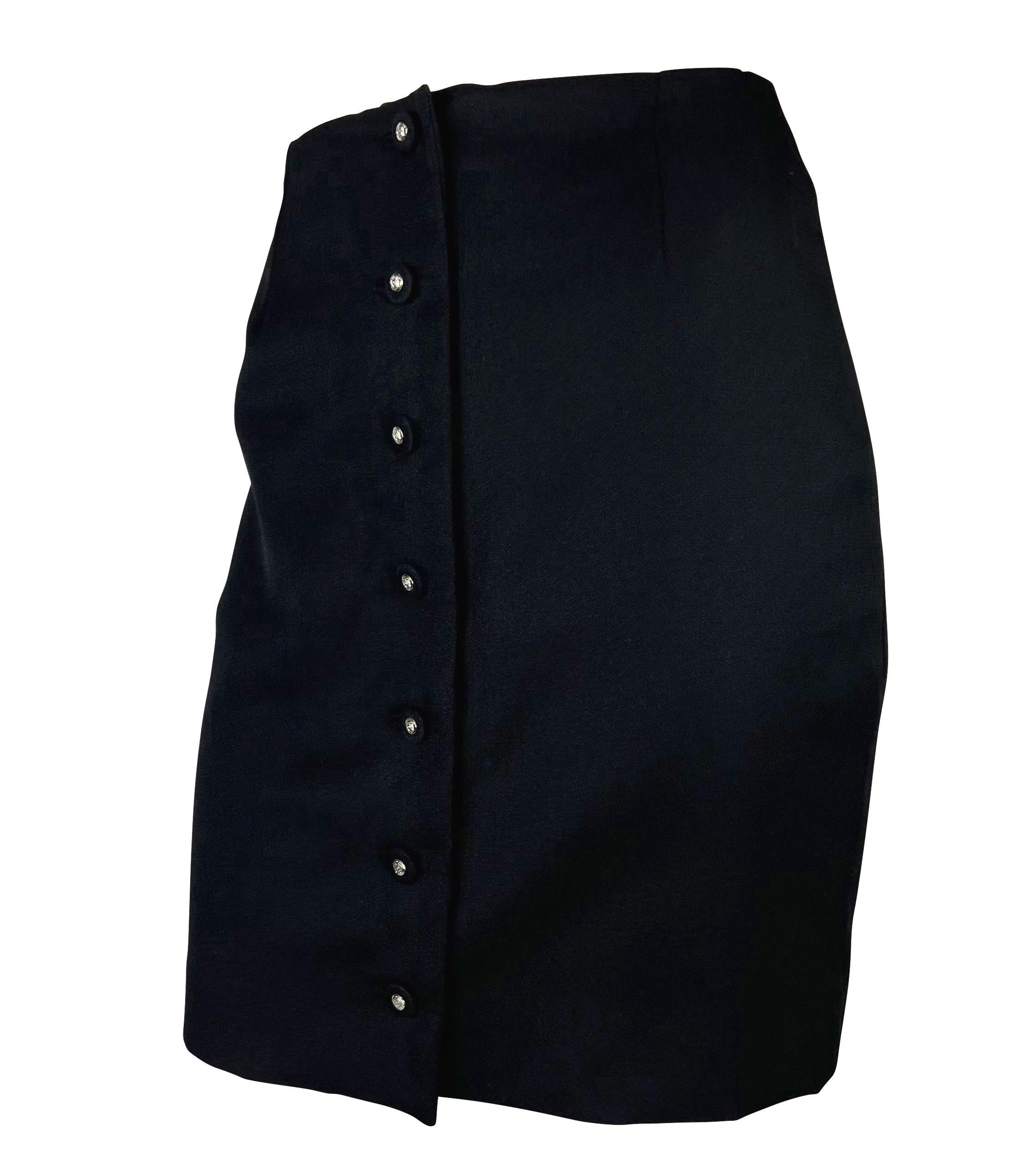 Presenting a black stretch wool Gianni Versace pencil skirt, designed by Gianni Versace. From the Spring/Sumer 1996 collection, this beautiful black skirt is made complete with a row of cloth-covered silver tone Versace Medusa button closures. The