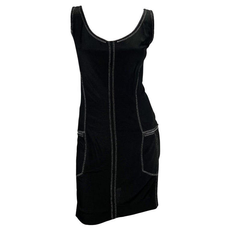 TheRealList presents: a black sleeveless Gianni Versace Couture dress, designed by Gianni Versace. From the Spring/Summer 1996 collection, this knit dress is finished with silver stitching and rhinestone accented zipper pockets at either hip. A