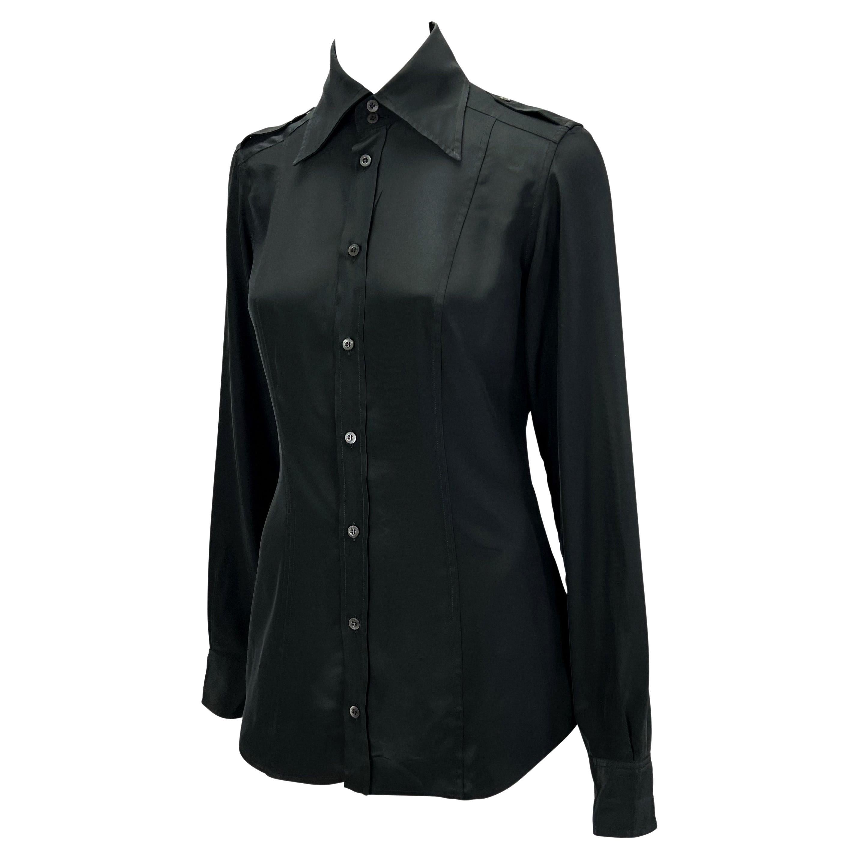 Presenting a black collared button-up Gucci top, designed by Tom Ford. Constructed of panels of lightweight polyester, this top has long sleeves, a prominent collar, and epaulets. Not your average top, this shirt was designed for the Spring/Summer