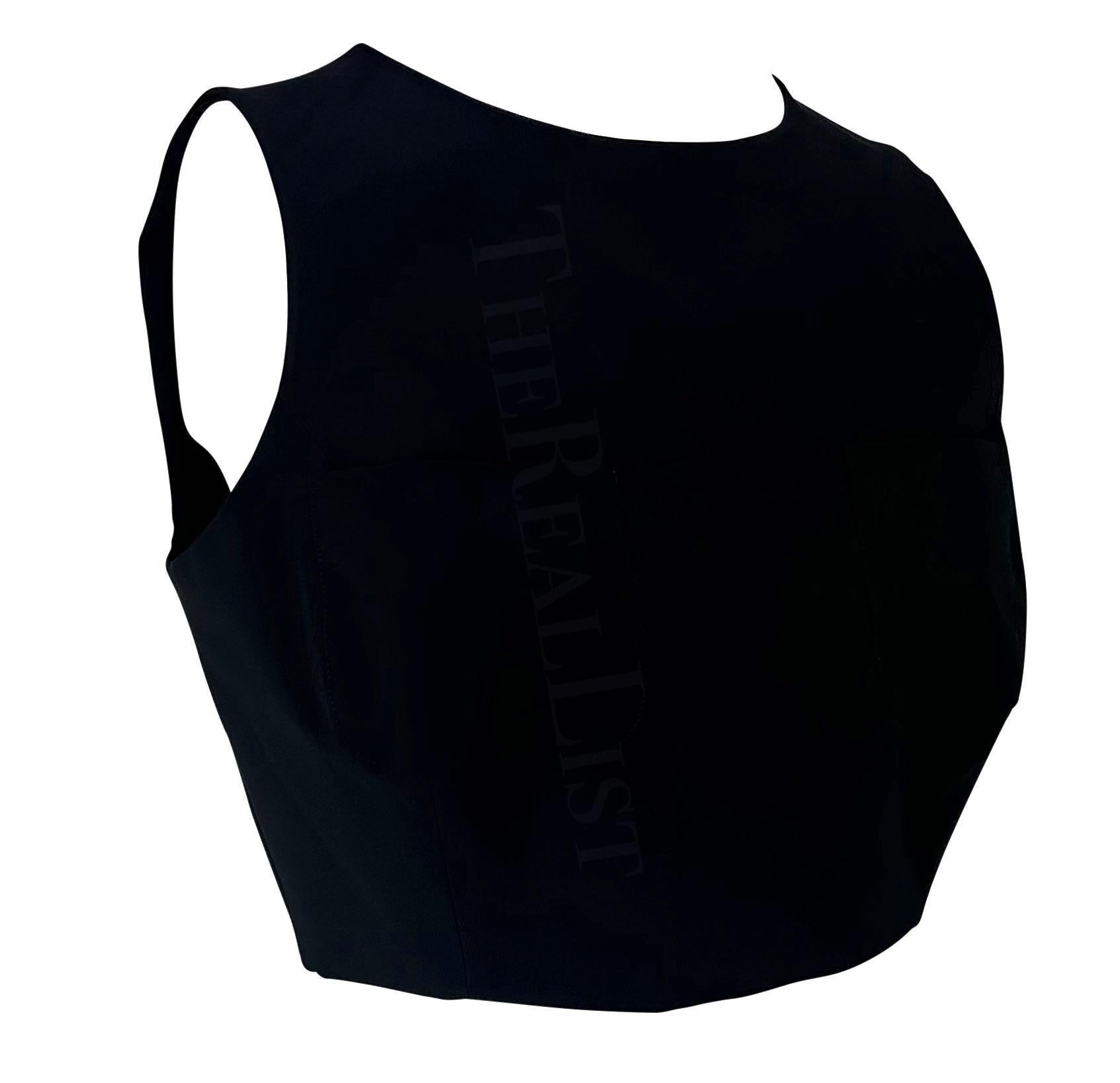 Ti presentiamo un favoloso crop top nero di Gucci, disegnato da Tom Ford. Dalla collezione primavera/estate 1996, questo crop top chic senza maniche presenta una scollatura a girocollo e due tasche sul busto. Aggiungi al tuo guardaroba questo crop
