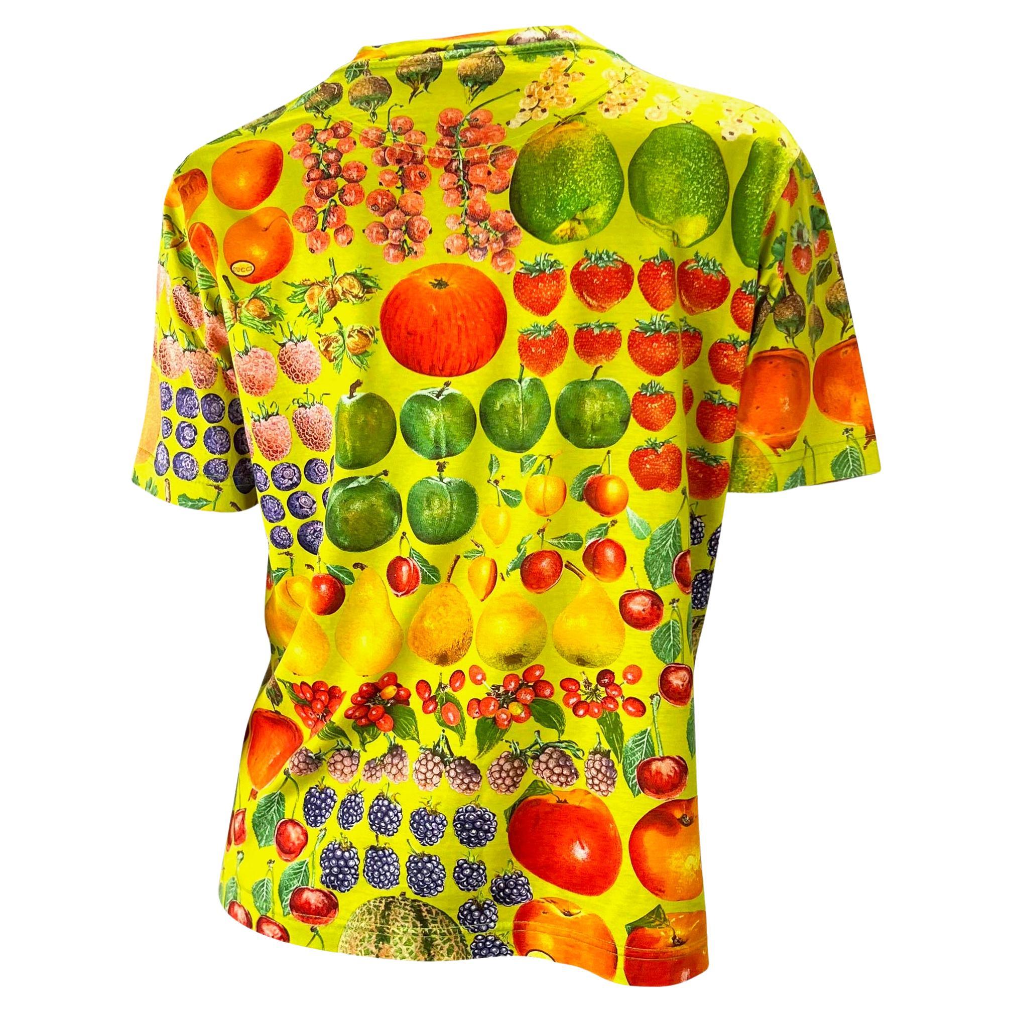 Presenting a vibrantly printed green t-shirt designed by Tom Ford for Gucci's Spring/Summer 1996 collection. The fruit print features the Gucci signature cleverly placed as stickers on the fruit. This rare and collectible shirt references Gucci's