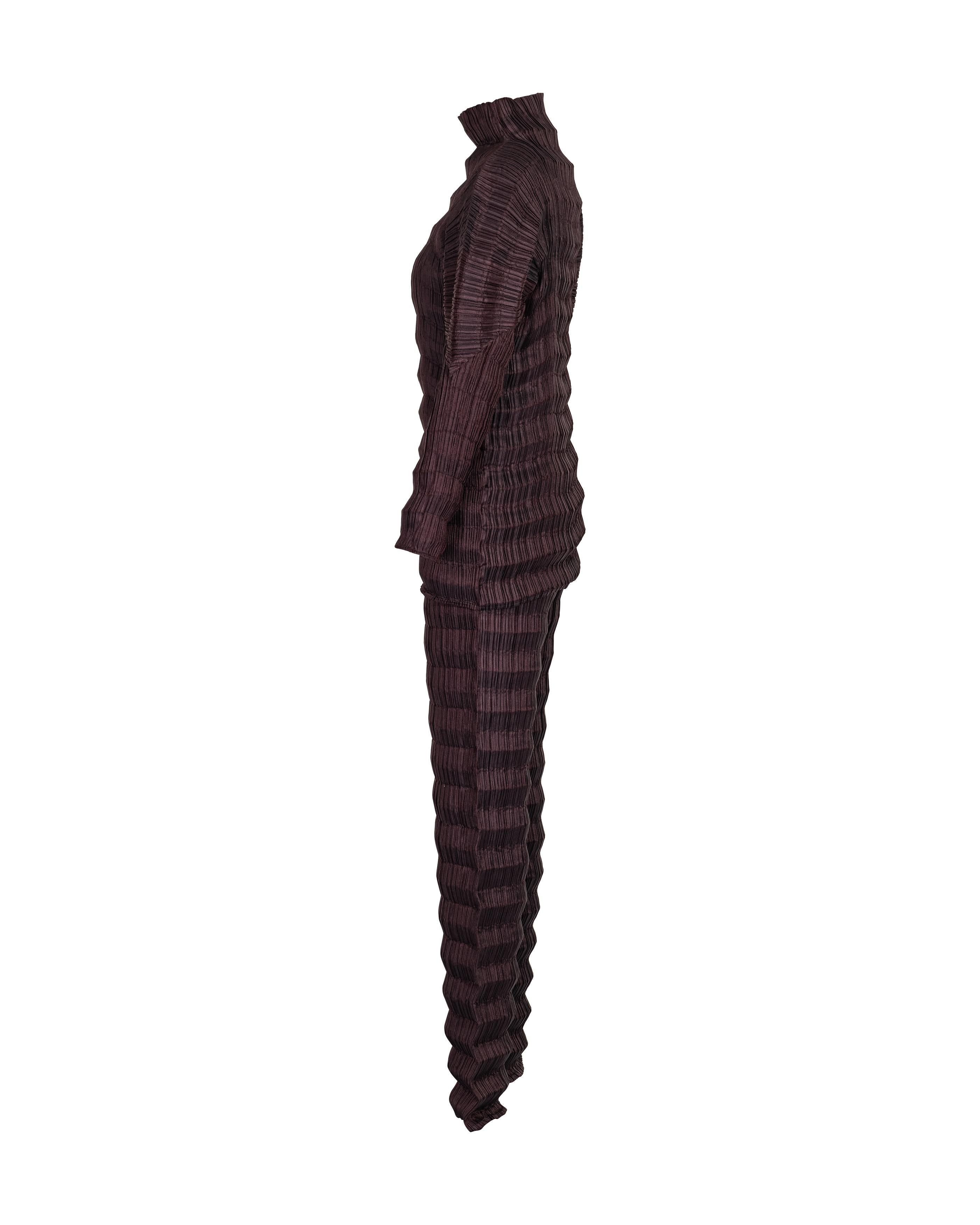 S/S 1996 Issey Miyake brown-purple pleated accordion pant set. Long sleeve pleated mock neck top with curved upper arms pairs with high rise pant. Slight metallic finish throughout. In excellent vintage condition with no flaws to note.

Marked size