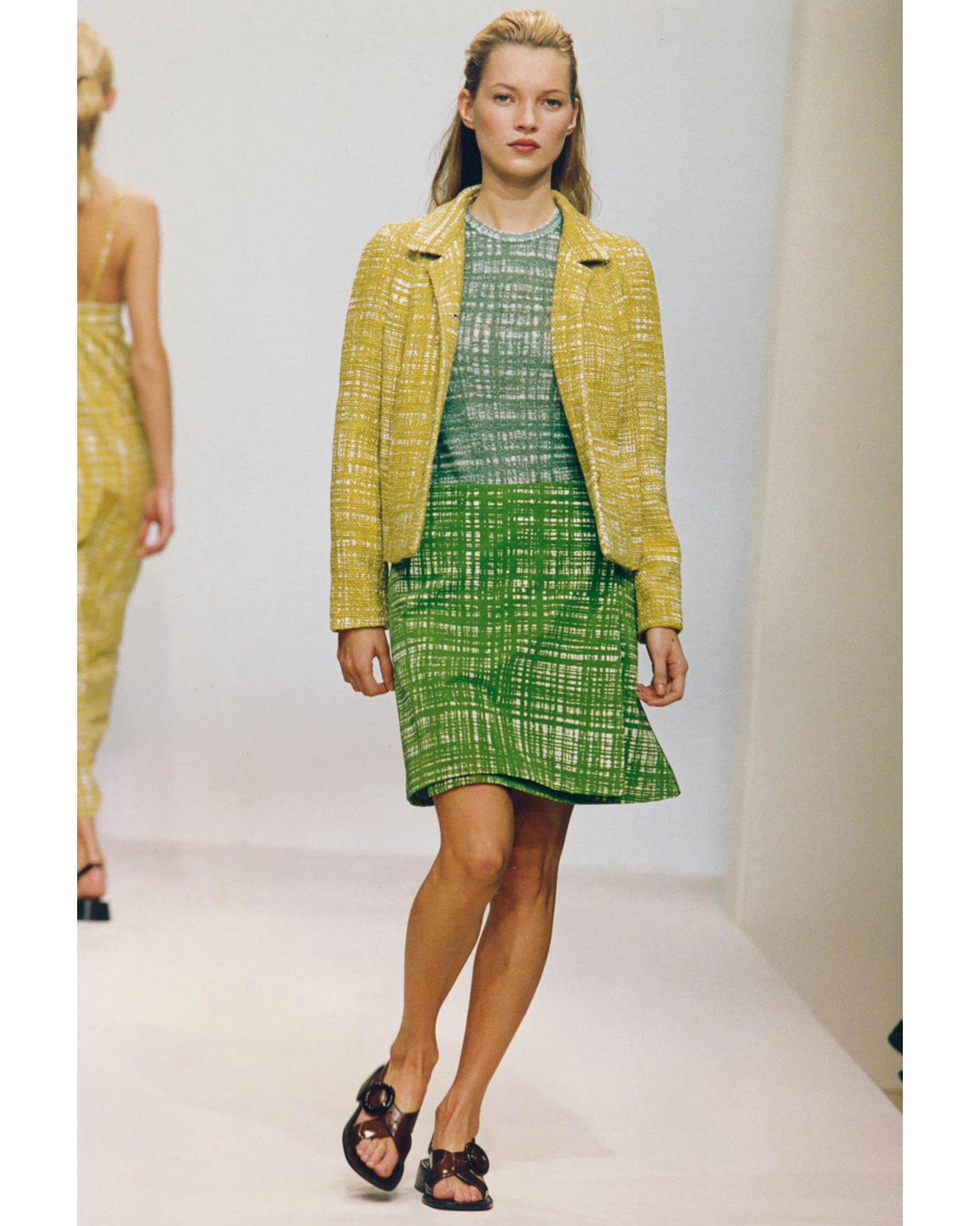 S/S 1996 Prada by Miuccia Prada yellow-green 'ugly chic' tweed skirt set. Collared tweed blazer jacket with four yellow-green front button closures pairs with matching tweed mini skirt with concealed zip closure. Fabric Contents: 50% Cotton; 50%