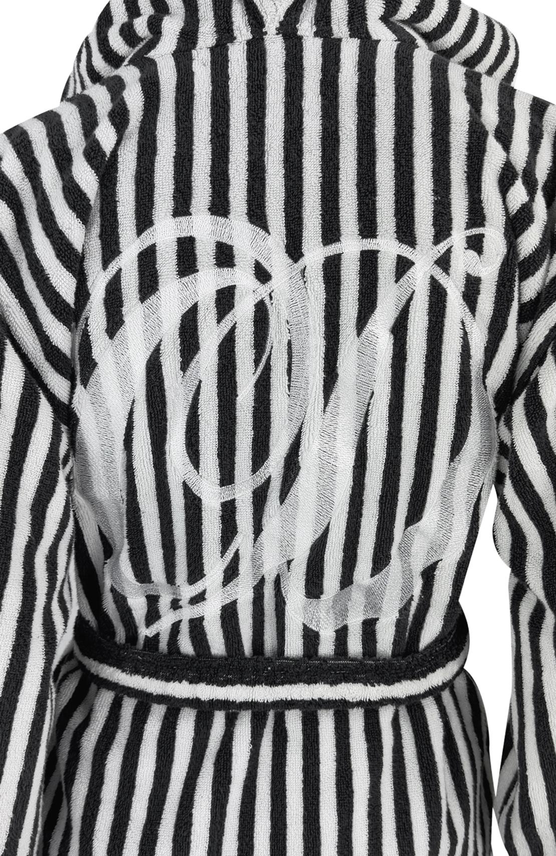 From Christian Dior's Spring/Summer 1997 collection under the direction of Gianfranco Ferré, this luxurious hooded robe features a bold black-and-white pattern, oversized pockets, and a matching belt. An embroidered 