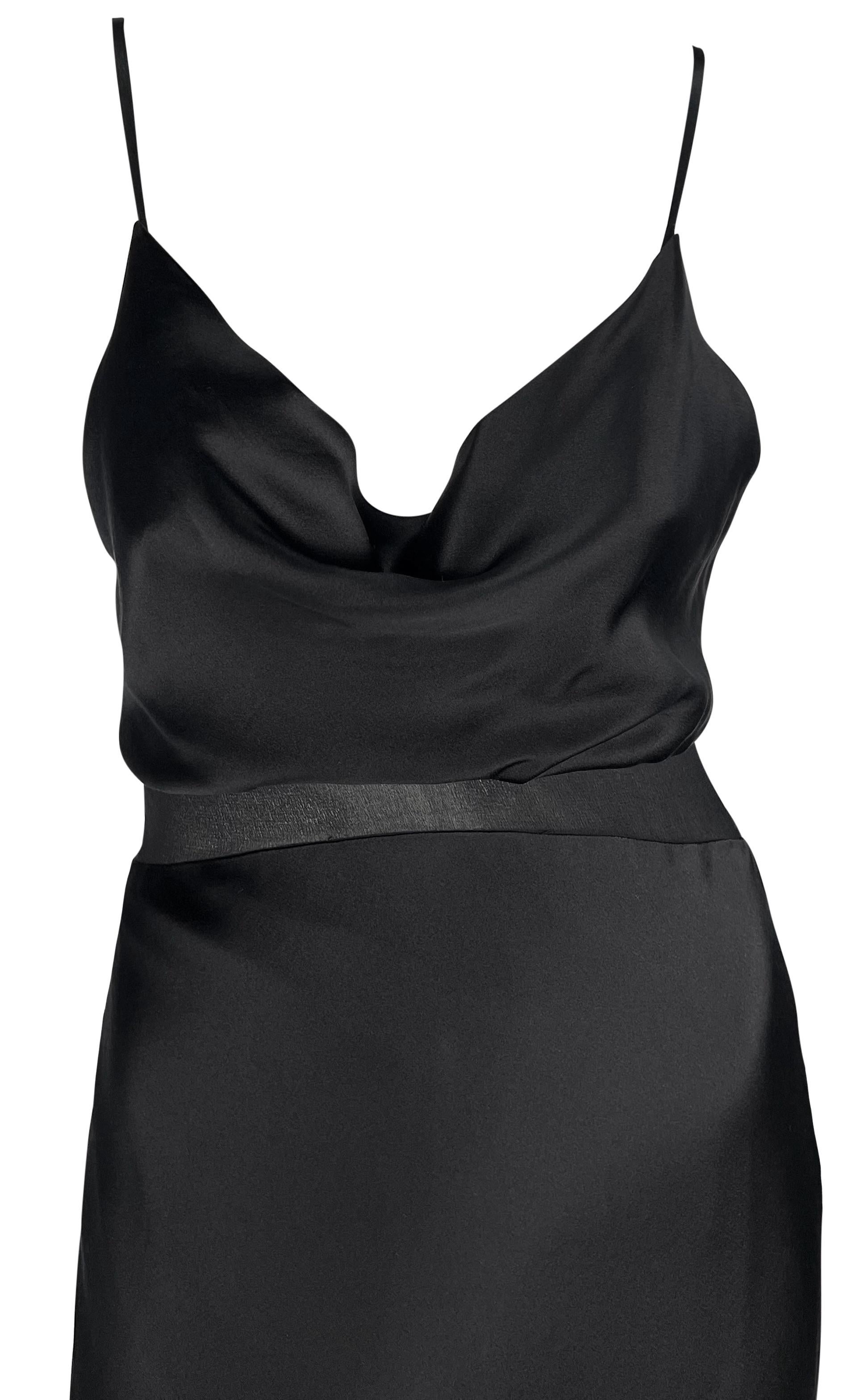Donatella Versace designed this sexy little black satin Gianni Versace dress with a sheer panel running under the bust and across the back. This chic slip-style dress features a cowl neckline, spaghetti straps, and a lightly flared hem. Simple,