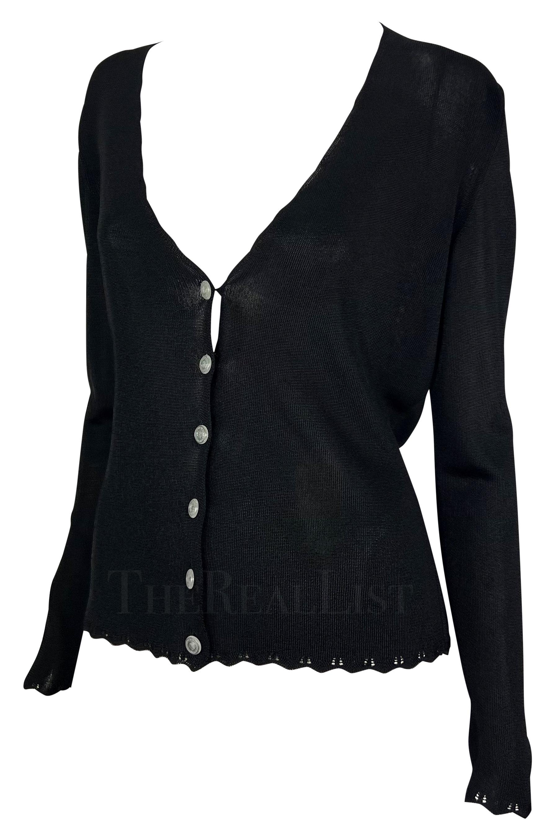 Presenting a fabulous black knit Gianni Versace cardigan, designed by Gianni Versace. From the Spring/Summer 1997 collection, this sweater features a wide v-neckline, scalloped details at the hem, cuffs, and neckline, and is made complete with clear