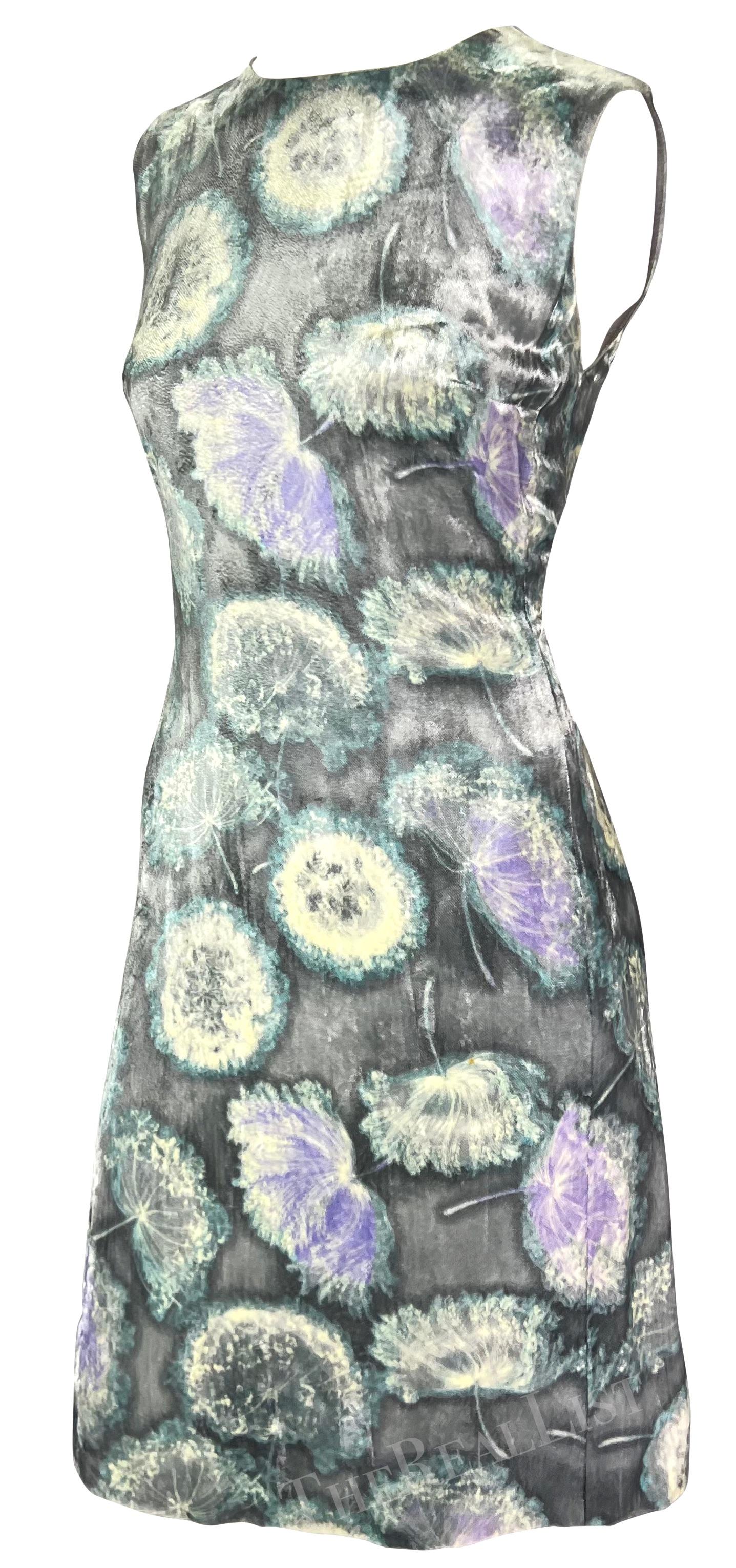 Presenting a fabulous silver dandelion print Gianni Versace dress, designed by Gianni Versace. From the Spring/Summer 1997 collection, this dress is constructed entirely of shimmery silver velvet with a bold dandelion print. A classic crew neckline