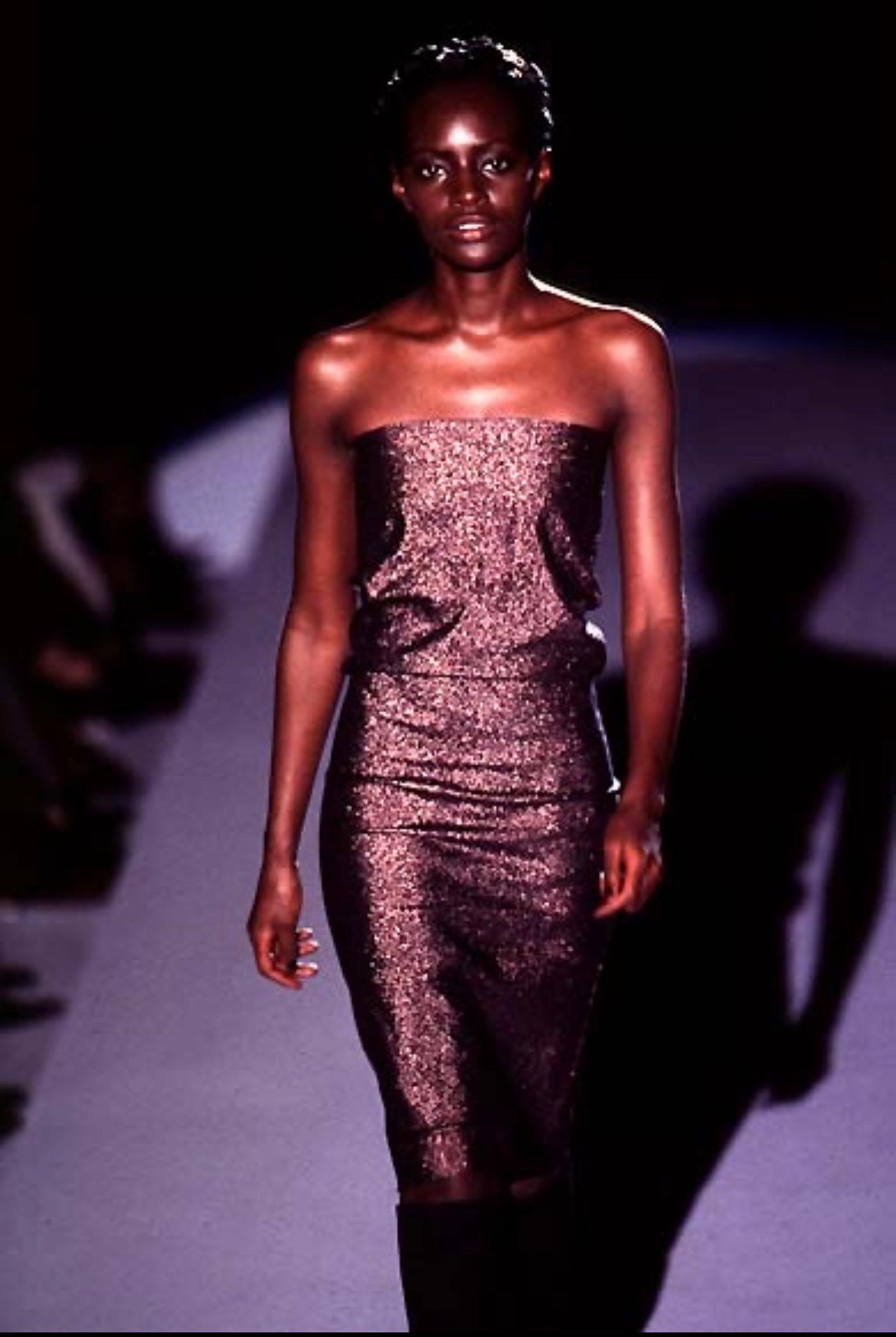 Presenting a dark brown metallic Gucci tube dress, designed by Tom Ford. This dress debuted on the Spring/Summer 1997 runway presentation on Kiara Kabukuru. Make this dress your own by styling it with a gathered look at the waist or pulled down to